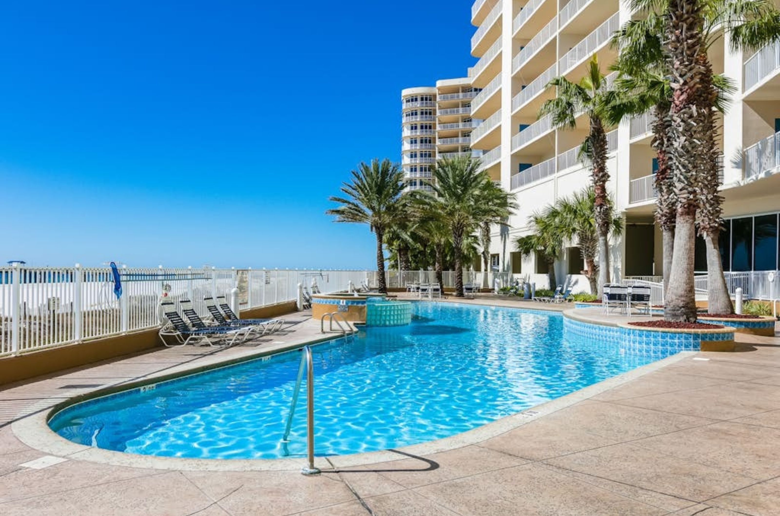 The outdoor swimming pool in front of Admirals Quarters in Orange Beach Alabama 