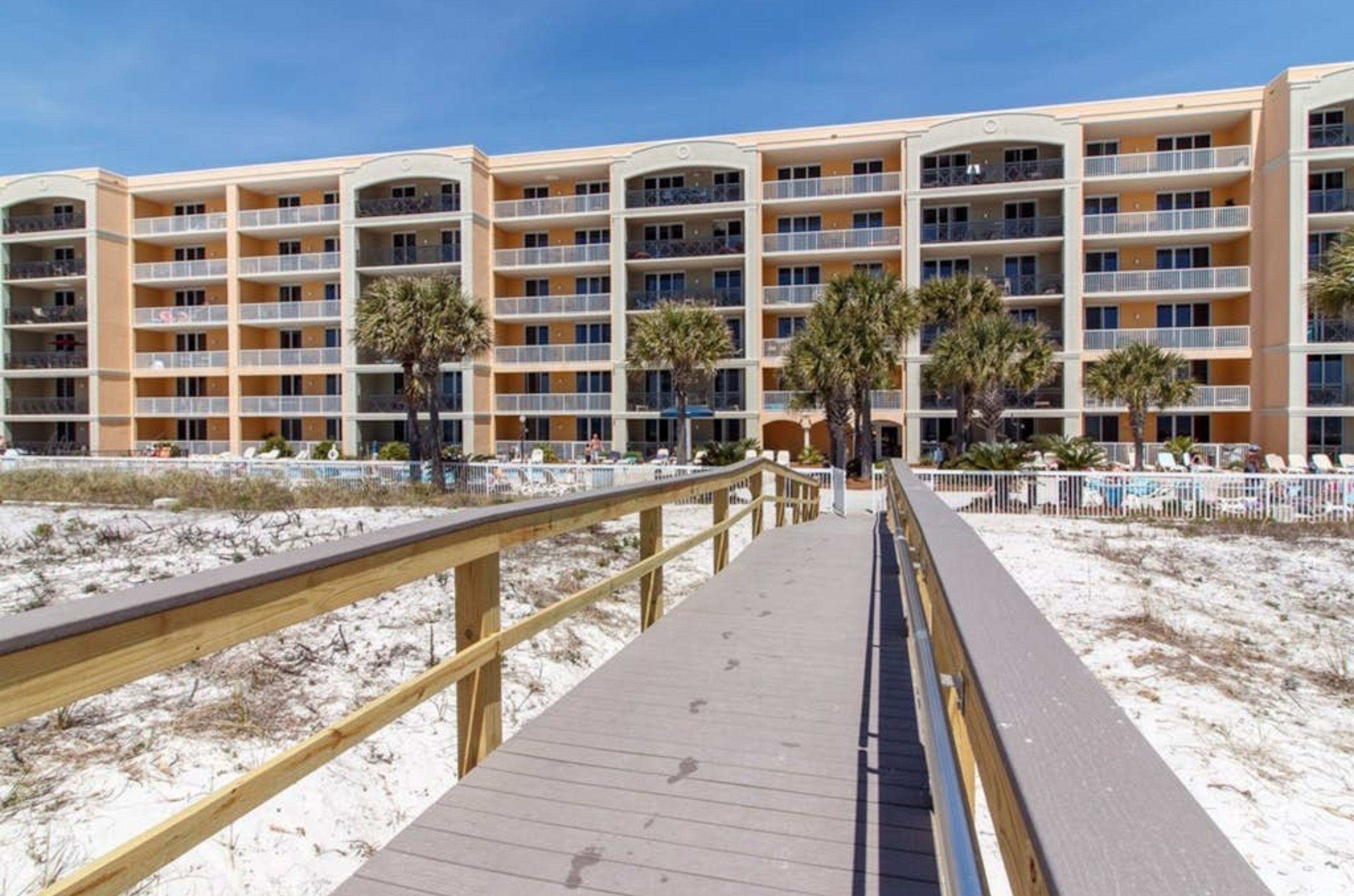 The beachside exterior of Azure Condominiums with the boardwalk leading from the beach in Fort Walton Beach Florida 