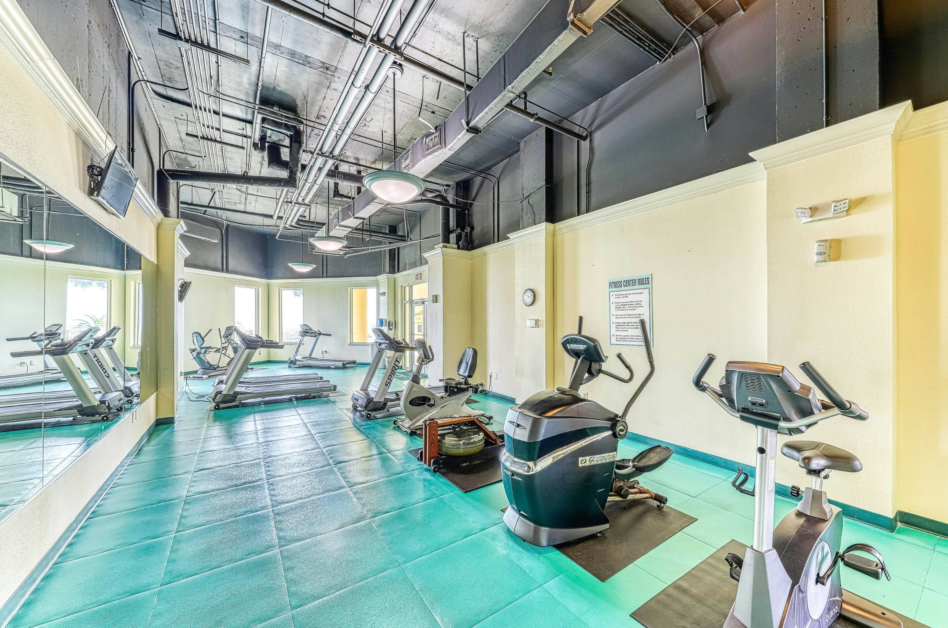 Cardio equipment and floor-to-ceiling mirrors in the resort's fitness center