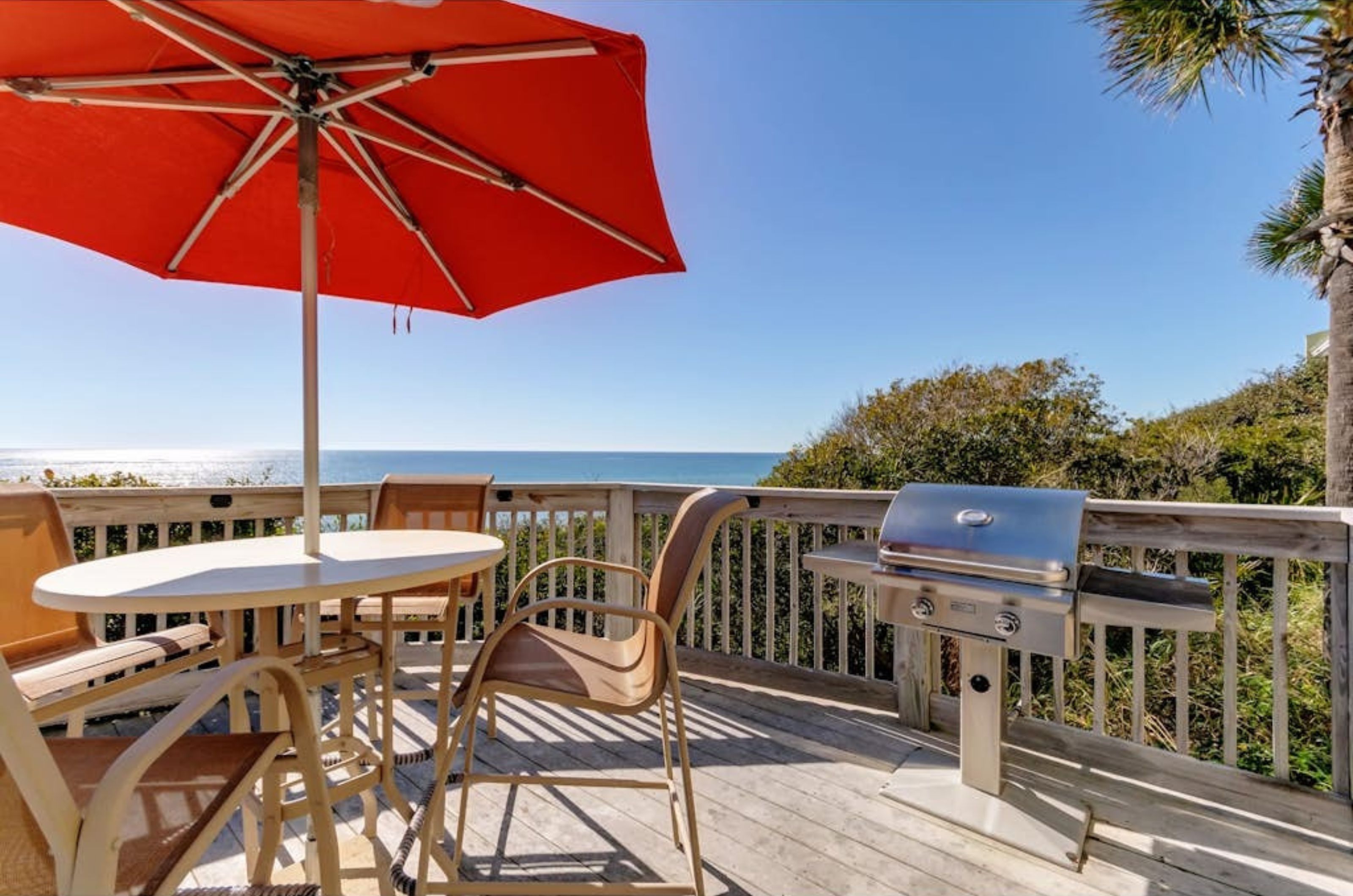 A private balcony with a dining tables and chairs at Bella Vita in Santa Rosa Beach Florida 