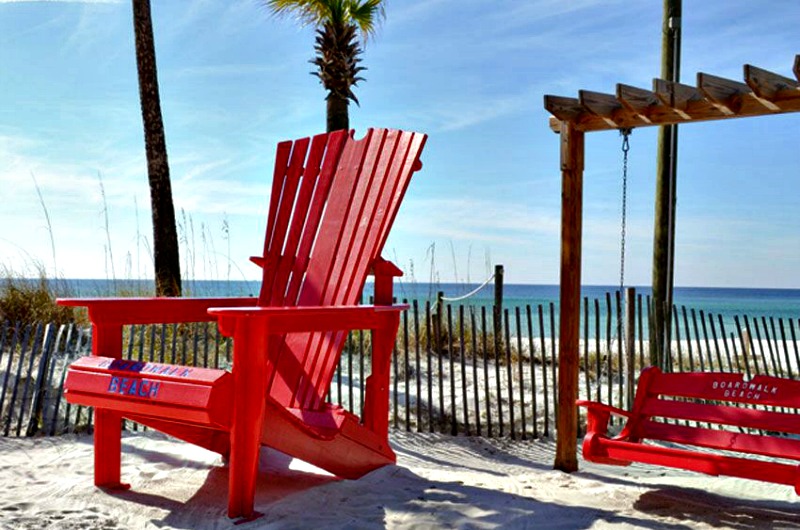 Bright red chair and swing on the beach at Boardwalk Beach Resort Hotel in Panama City