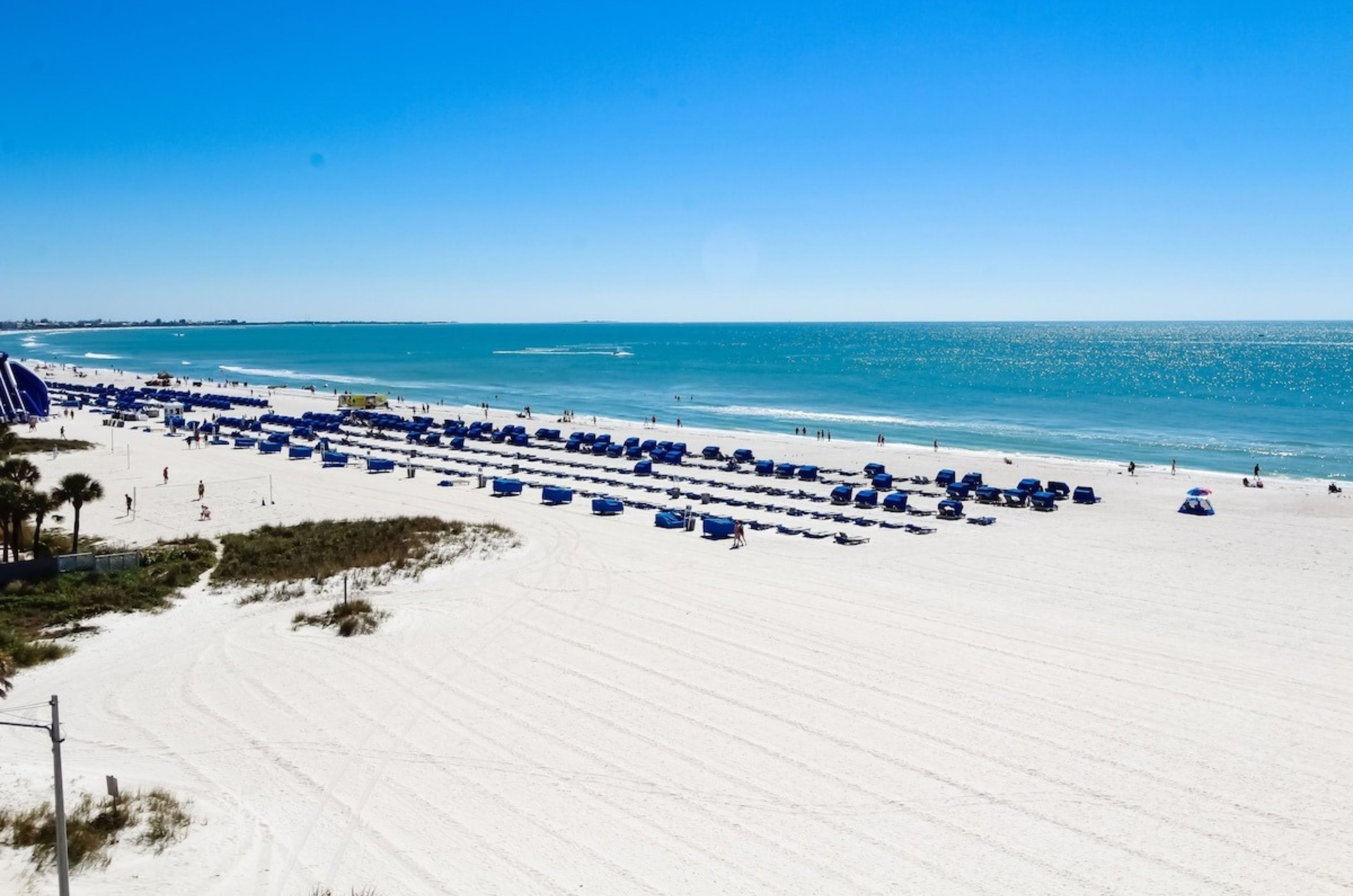 Aerial view of the beach with chairs and umbrellas next to the Gulf waters 