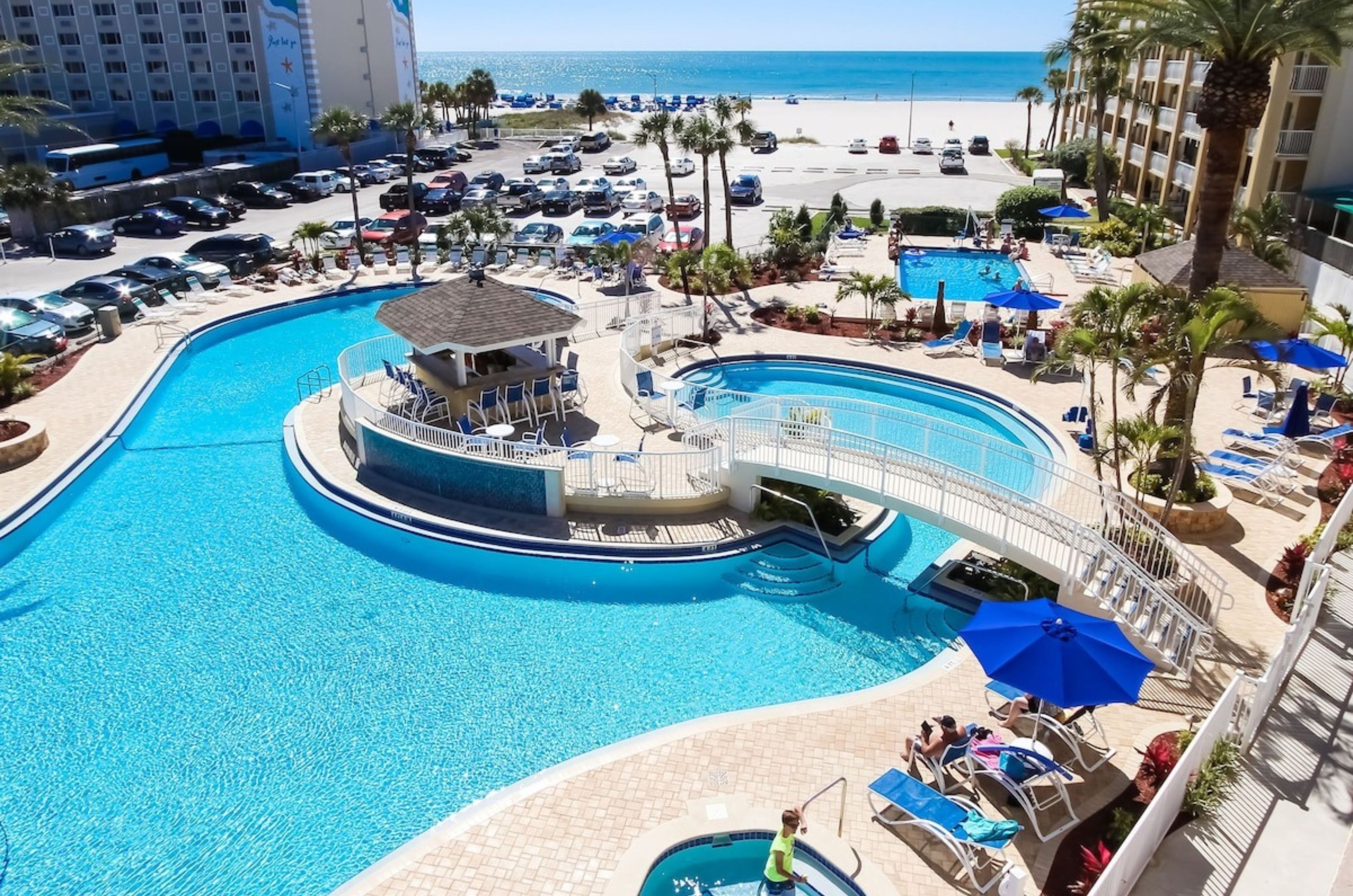 Aerial view of the outdoor pool area with a spacious pool deck bar and hot tub