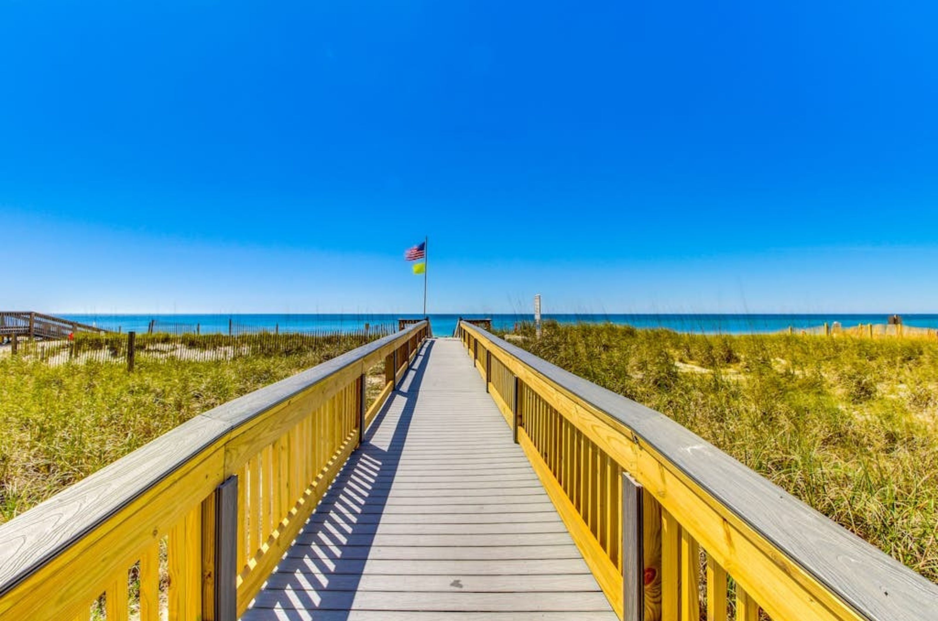 A wooden boardwalk leading to the beach at Crystal Towers