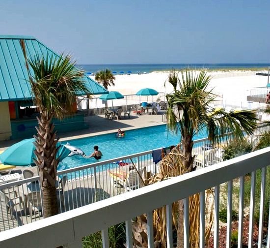 Balcony view of pool overlooking the beach at the Days Inn Pensacola Beachfront Hotel.