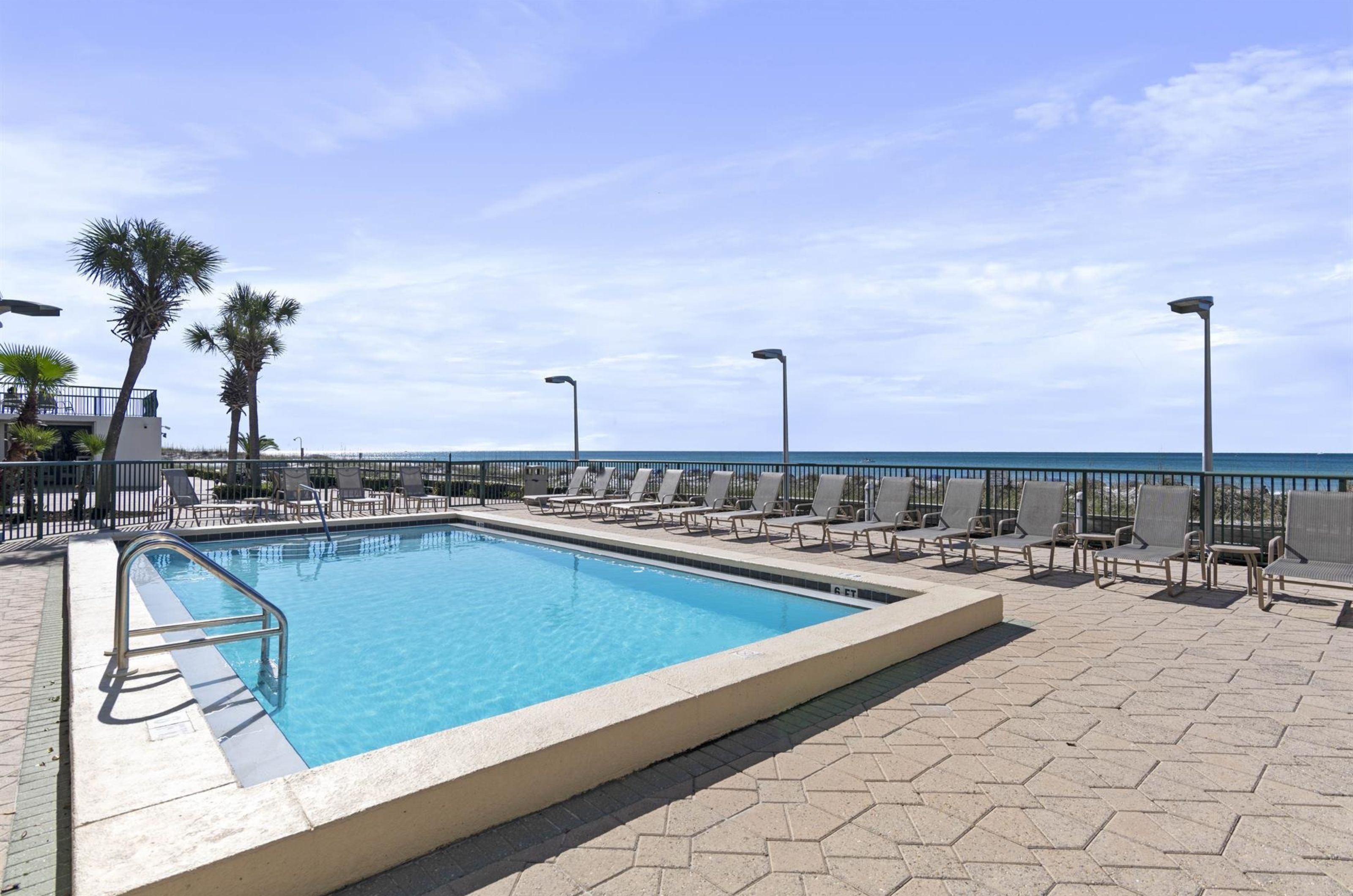 The outdoor swimming pool and pool deck at Destin Beach Club in Destin Florida 