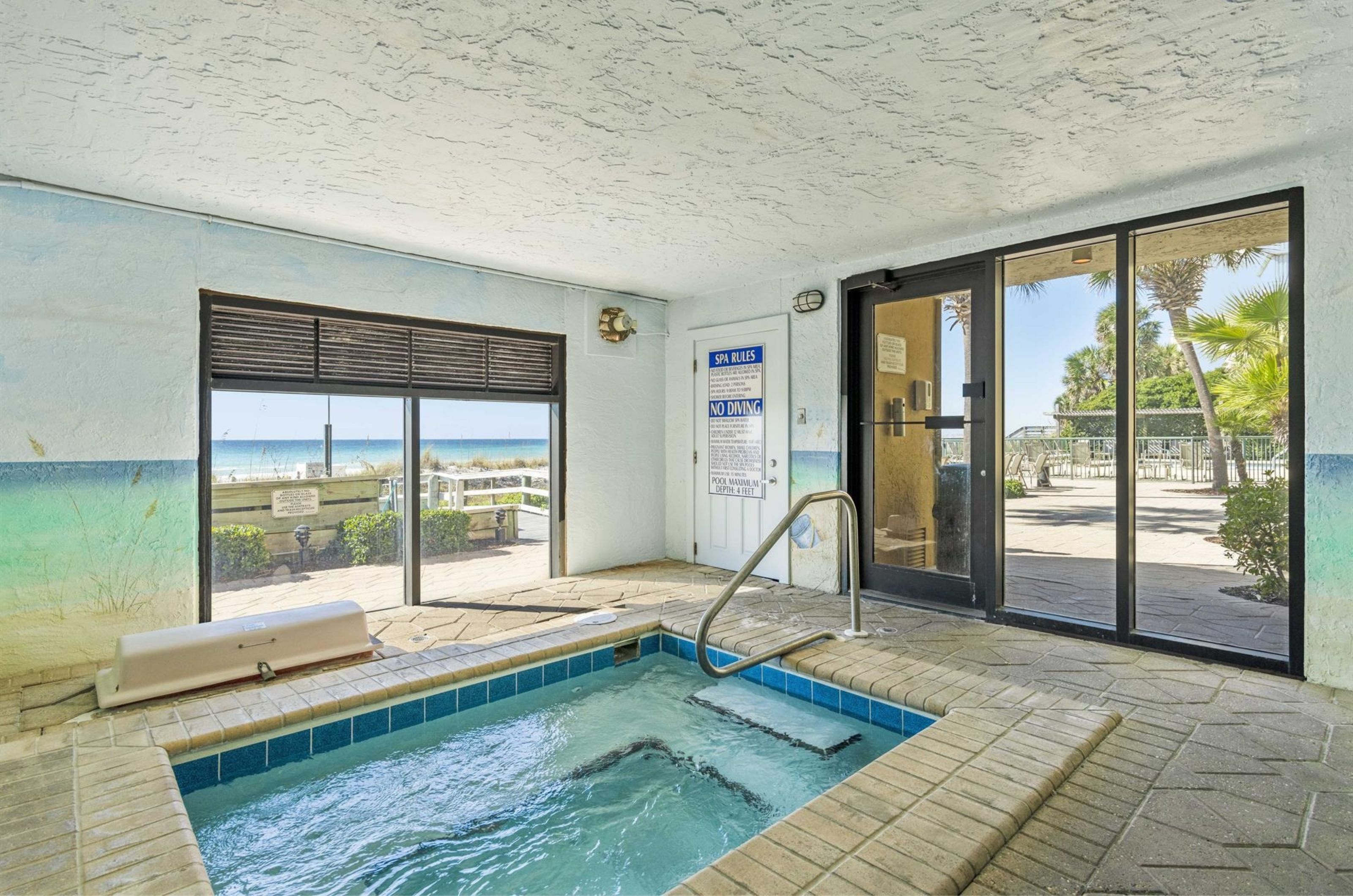 The indoor hot tub surrounded by windows at Destin Beach Club in Destin Florida	