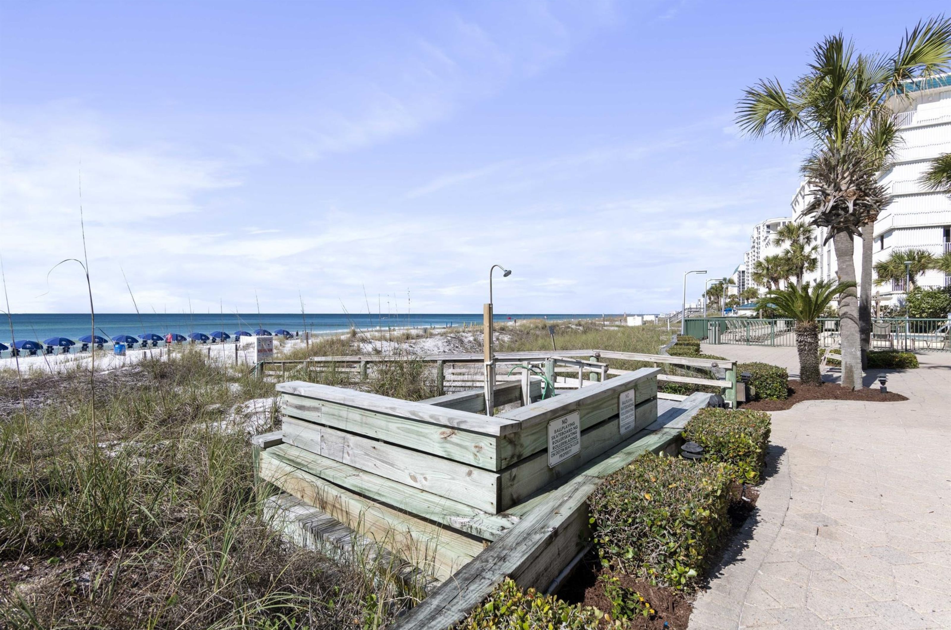 The outdoor showers on a wooden boardwalk atDestin Beach Club in Destin Florida 
