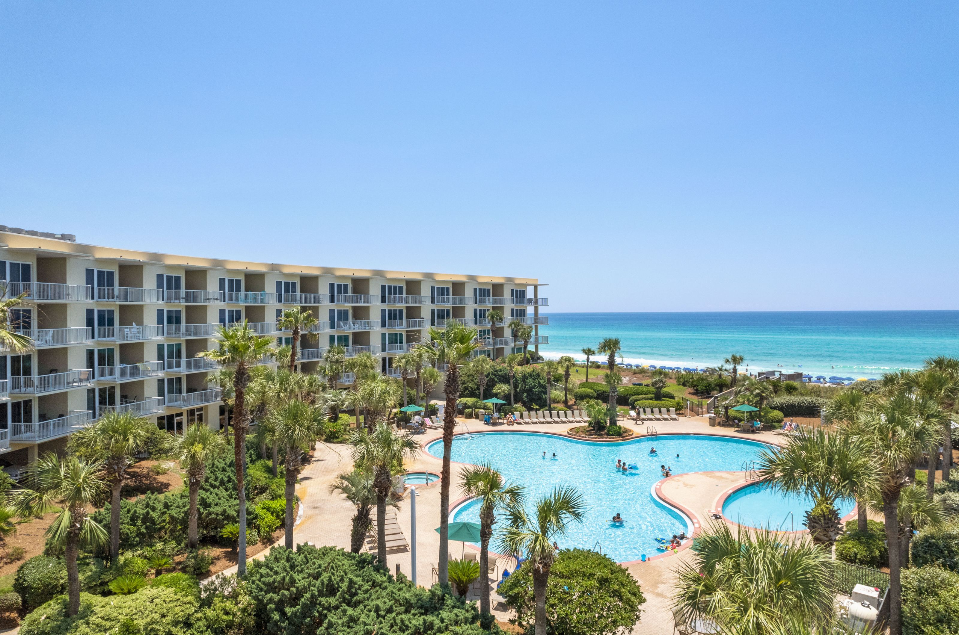 Crescent Condominium balconies overlooking the lagoon pool and Gulf of Mexico.