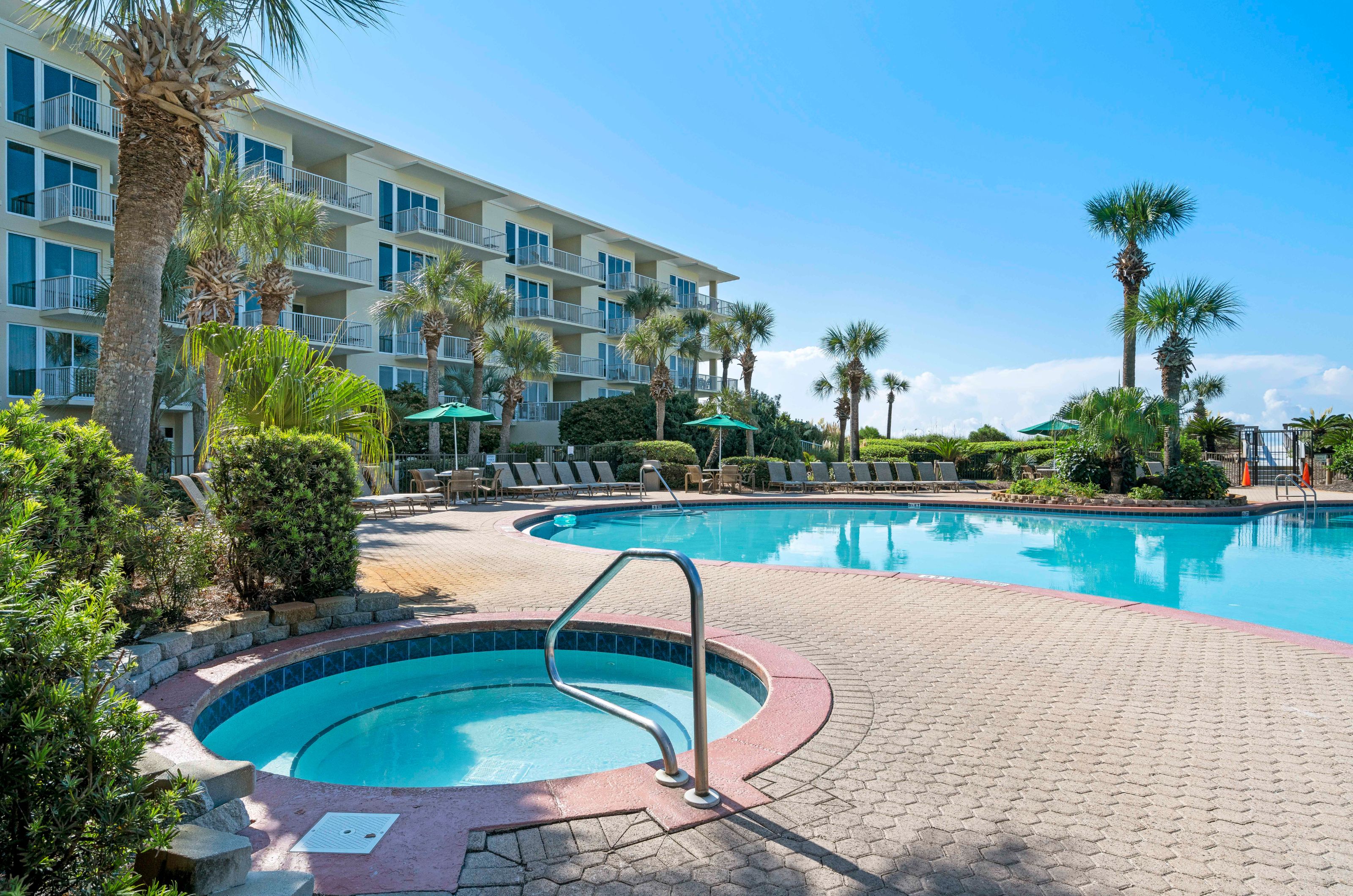 The hot tub and seasonally-heated swimming pool at Crescent Condos in Destin Florida