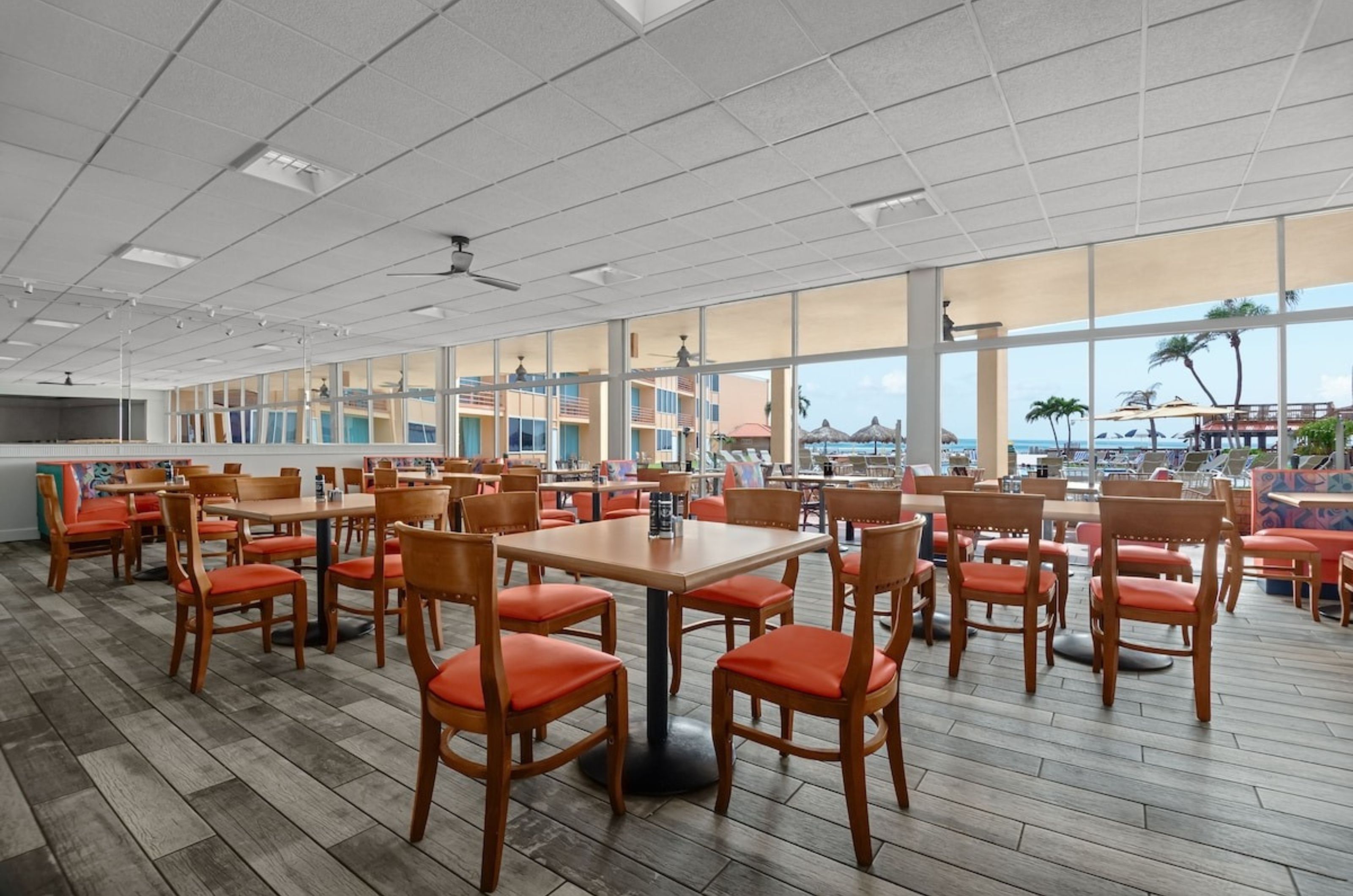 Dining tables and chairs in Dolphin Beach Resort's restaurant 