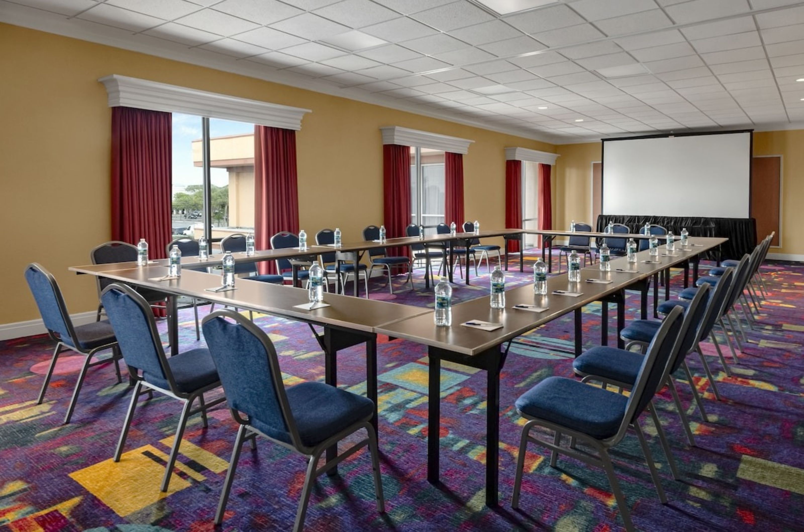 A large rectangular table with chairs in a conference room	