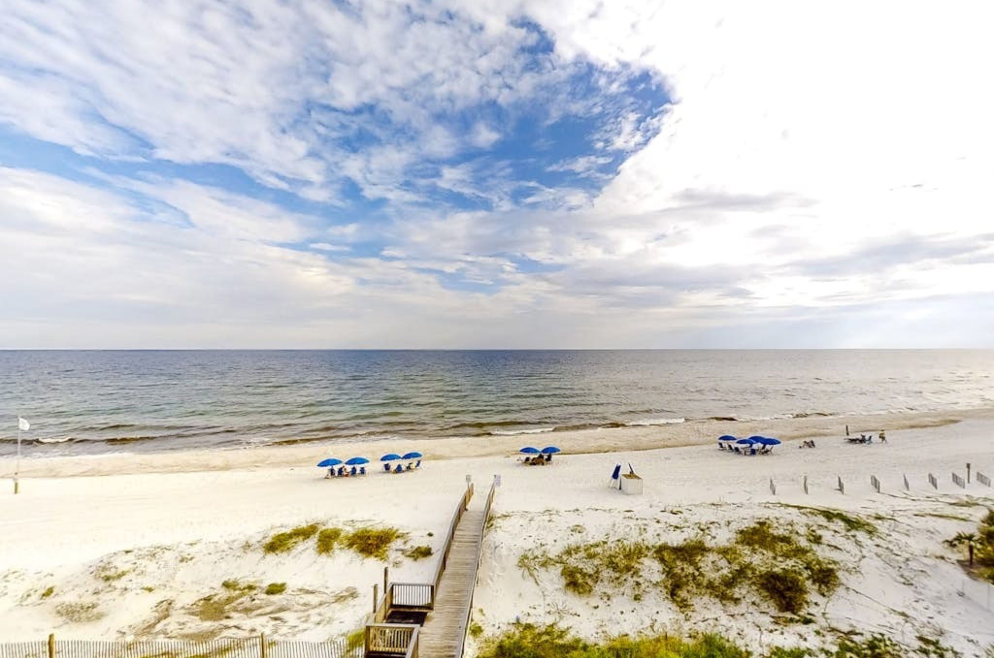 View from a private balcony of the wooden walkway leading to the beach at Dolphin Key 