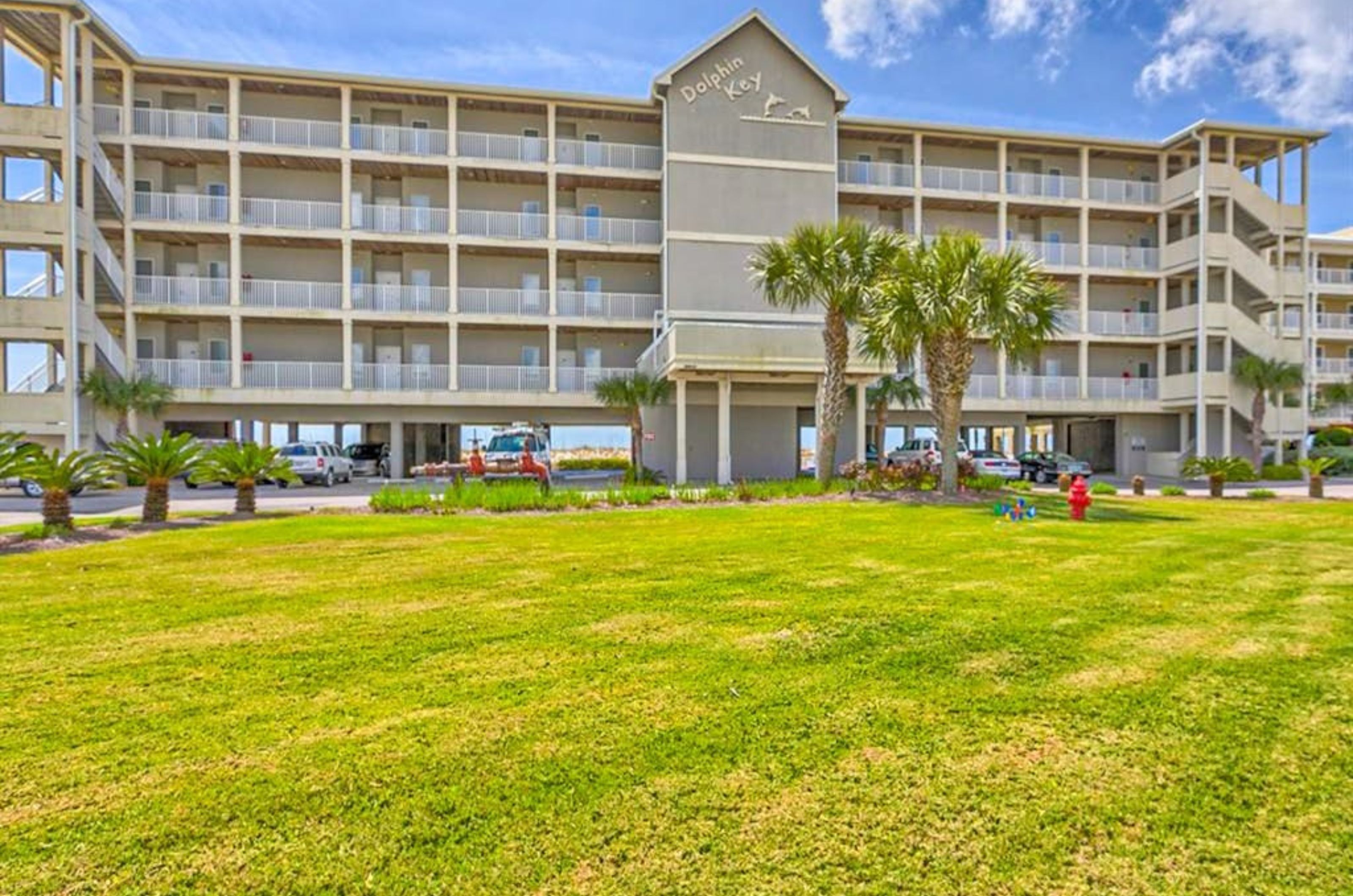 View of the exterior of Dolphin Key with the grassy lawn in front in Orange Beach Alabama 