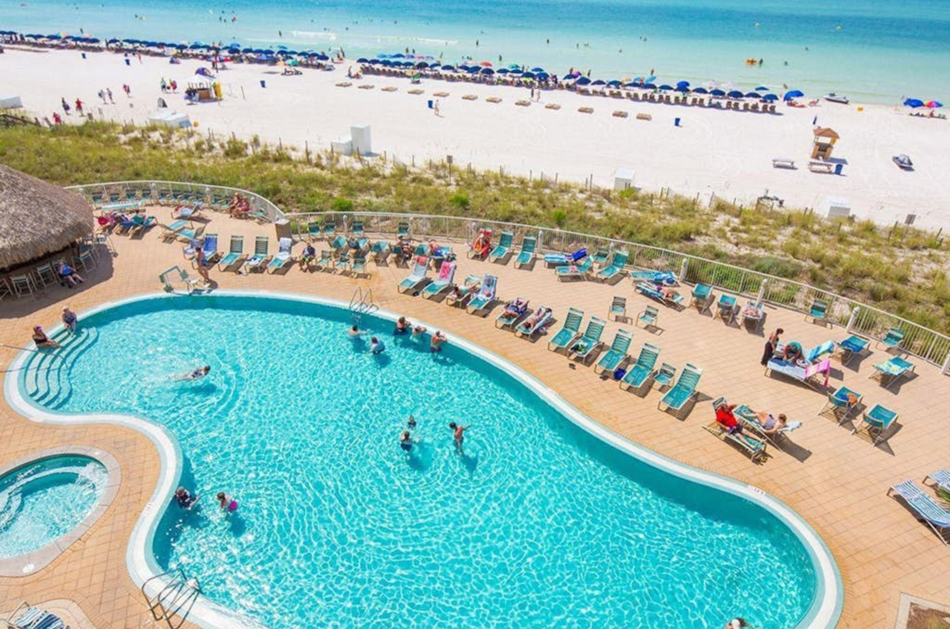 Aerial view of the outdoor pool next to the beach at Emerald Beach Resort in Panama City Beach Florida 