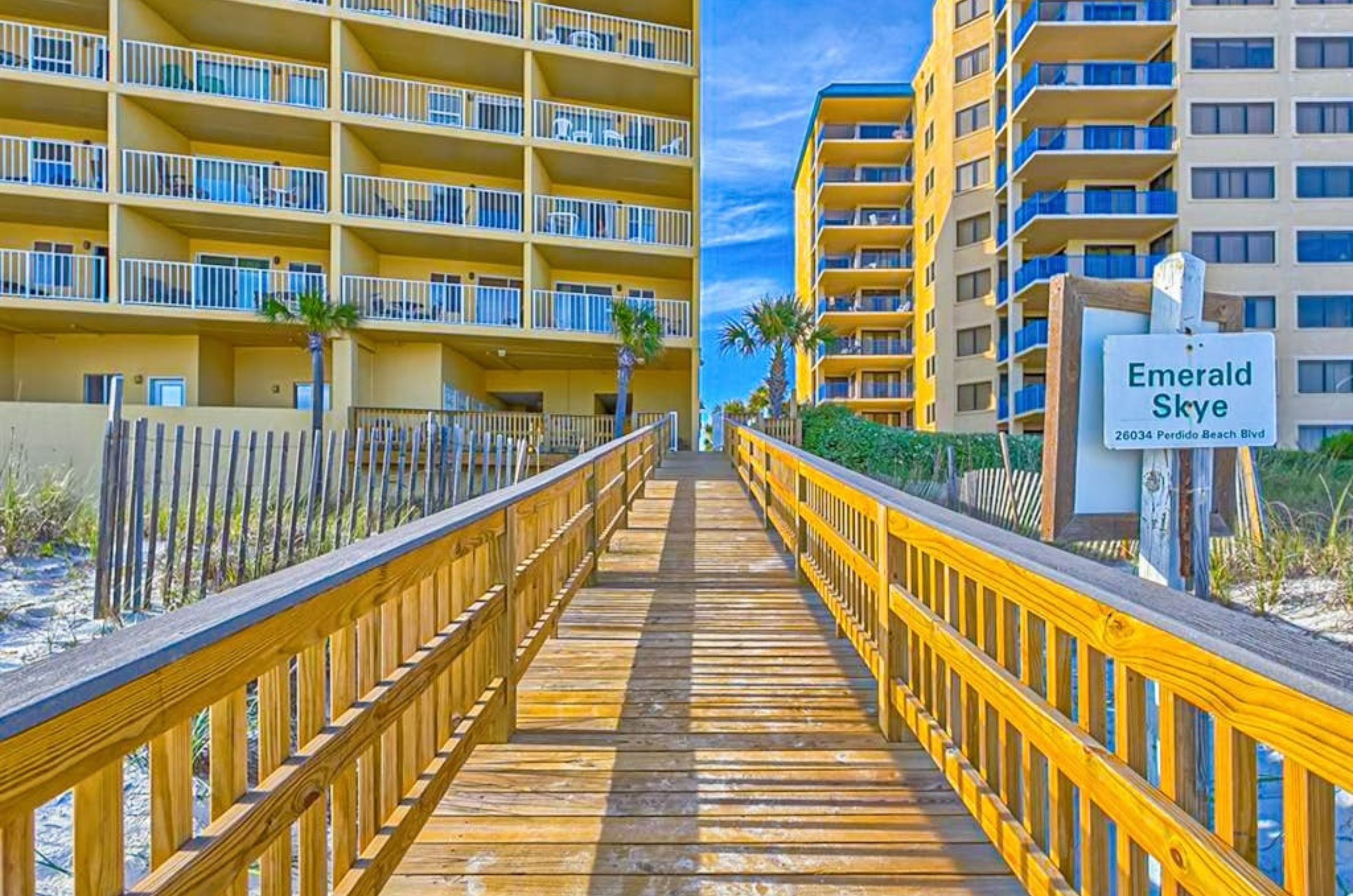 A wooden boardwalk leading towards Emerald Skye in Orange Beach Alabama