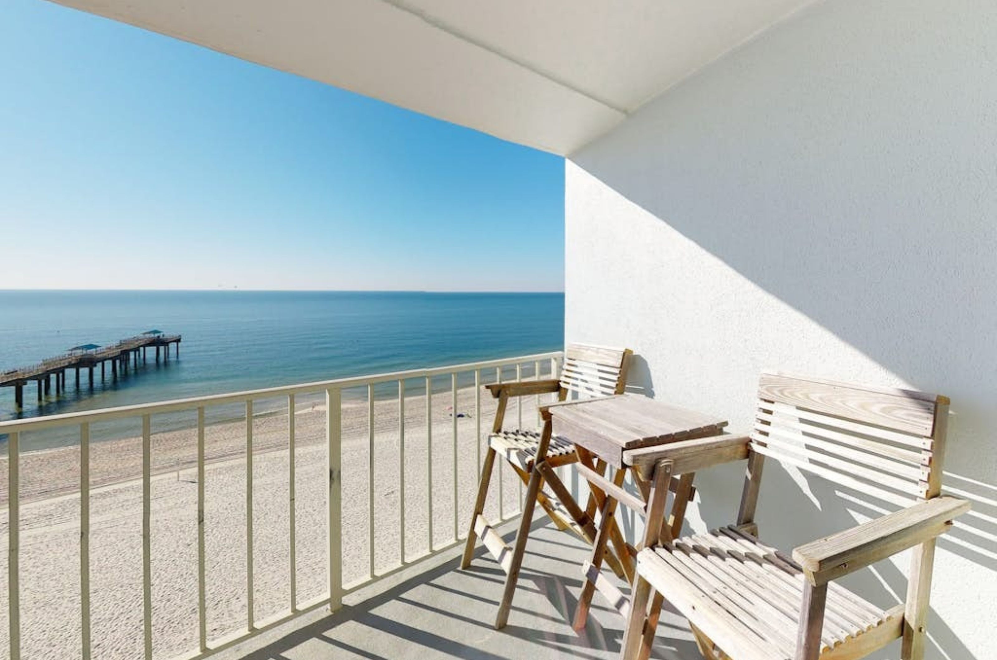 A table and chairs on a private balcony at Emerald Skye in Orange Beach Alabama	