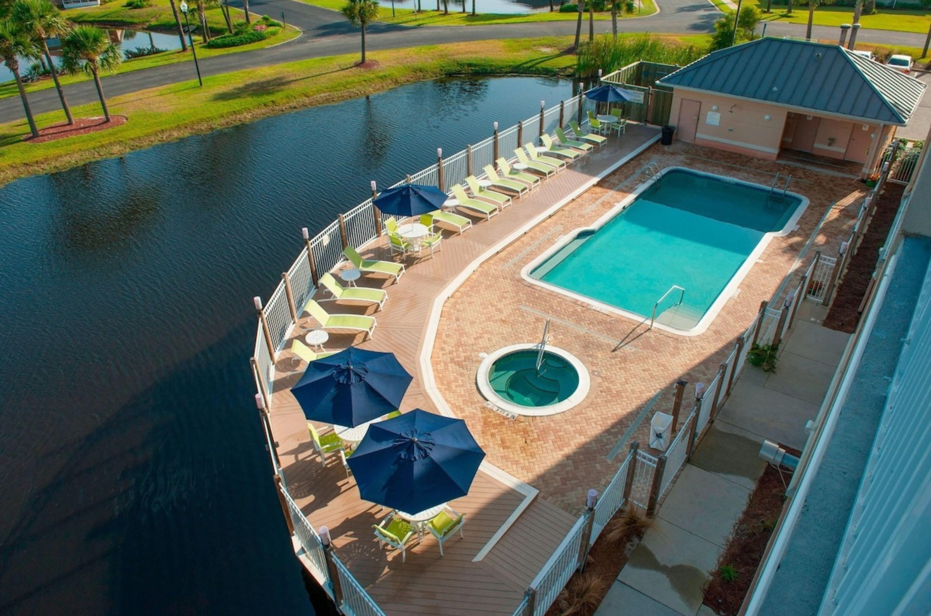 Aerial view of the outdoor pool and hot tub next to the water at Fairfield Inn and Suites