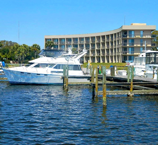 Dock with boat in private marina at Pirates' Bay Guest Chambers & Marina.