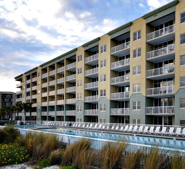 Beach-side exterior view of the property and pool at Waters Edge Condos in Fort Walton Florida