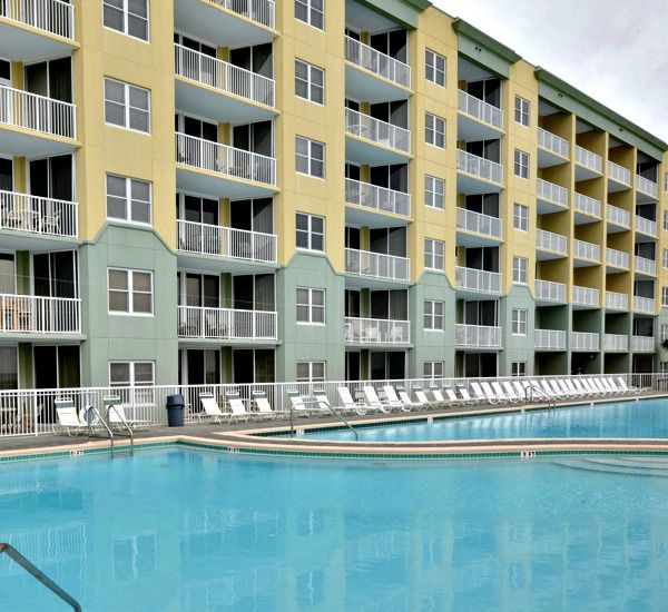 Beach-side exterior view and Gulf-front swimming pool at Waters Edge Condos in Fort Walton FL