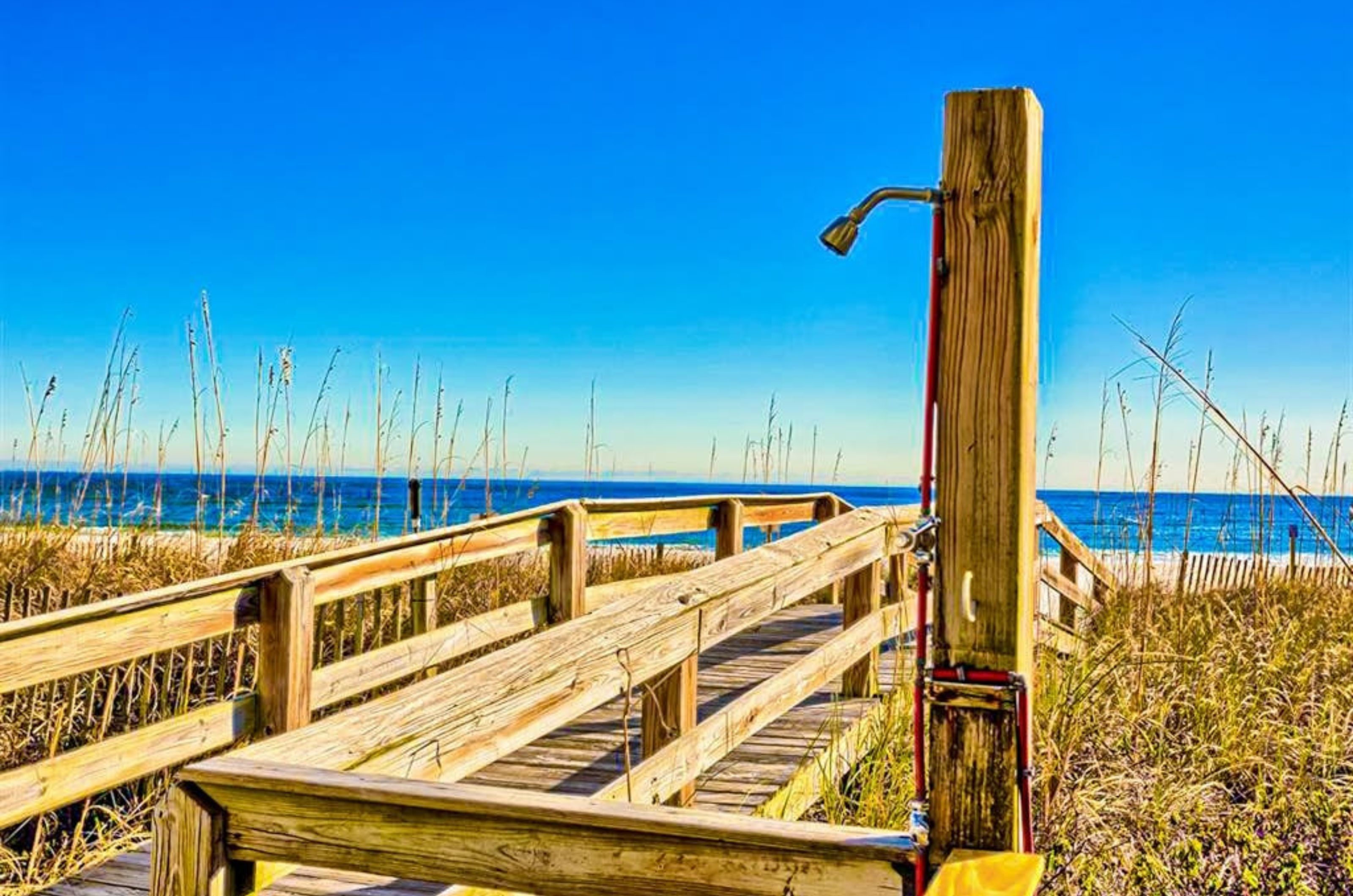 The outdoor shower next to the wooden boardwalk at Four Winds in Orange Beach Alabama 