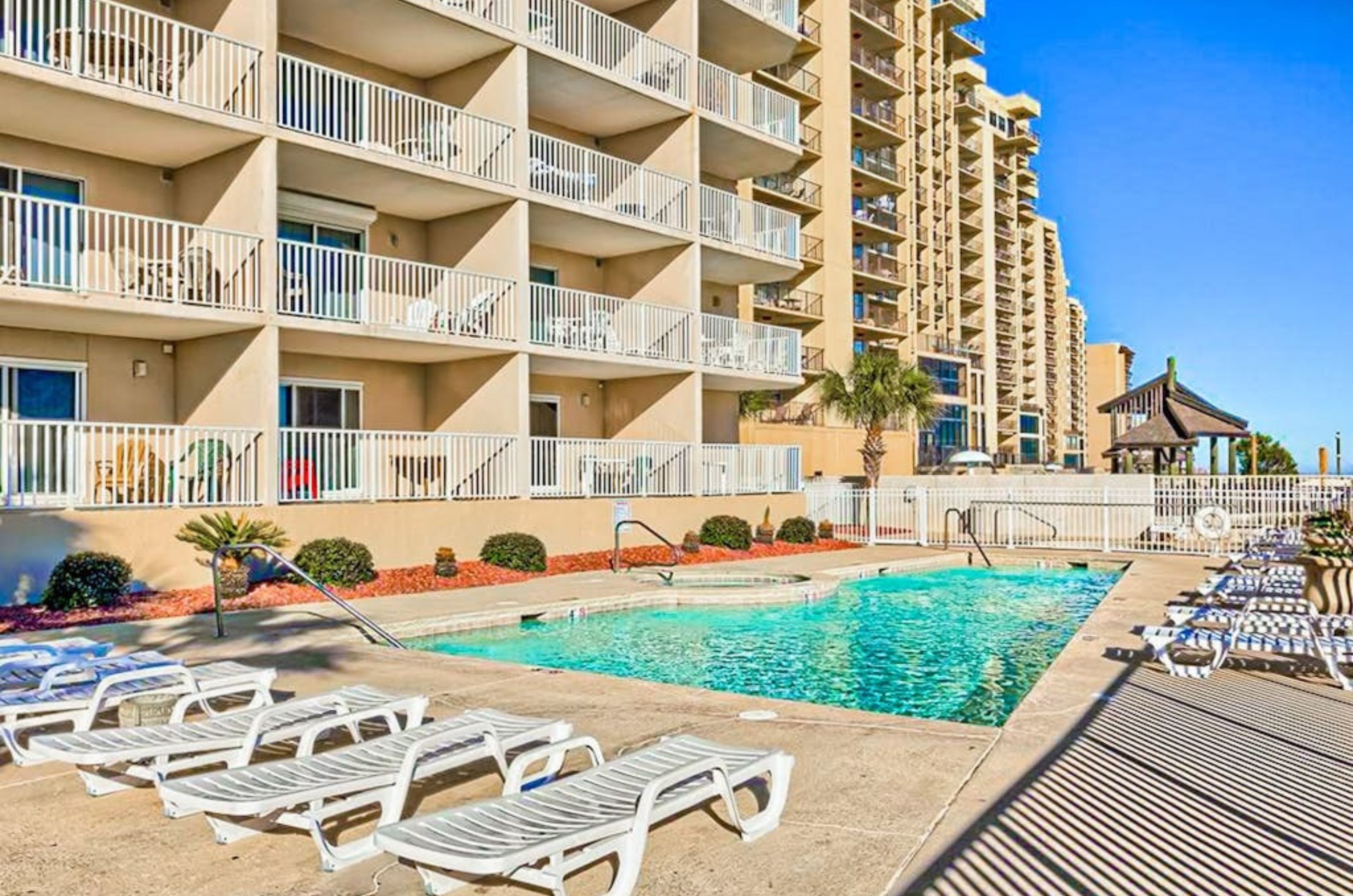 The outdoor pool and pool deck in front of Four Winds in Orange Beach Alabama 