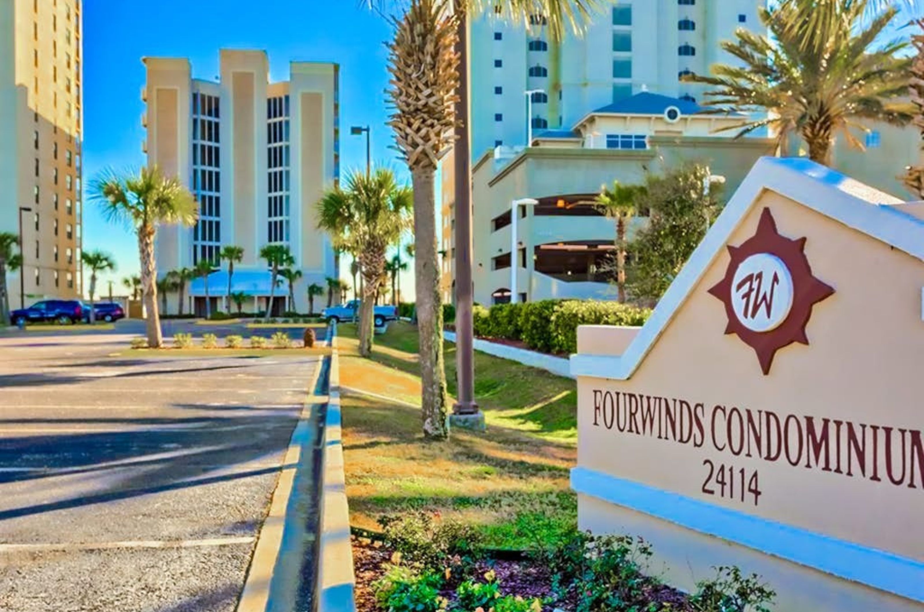 The entry sign in front of the condominium and complimentary parking at Four Winds in Orange Beach Alabama 