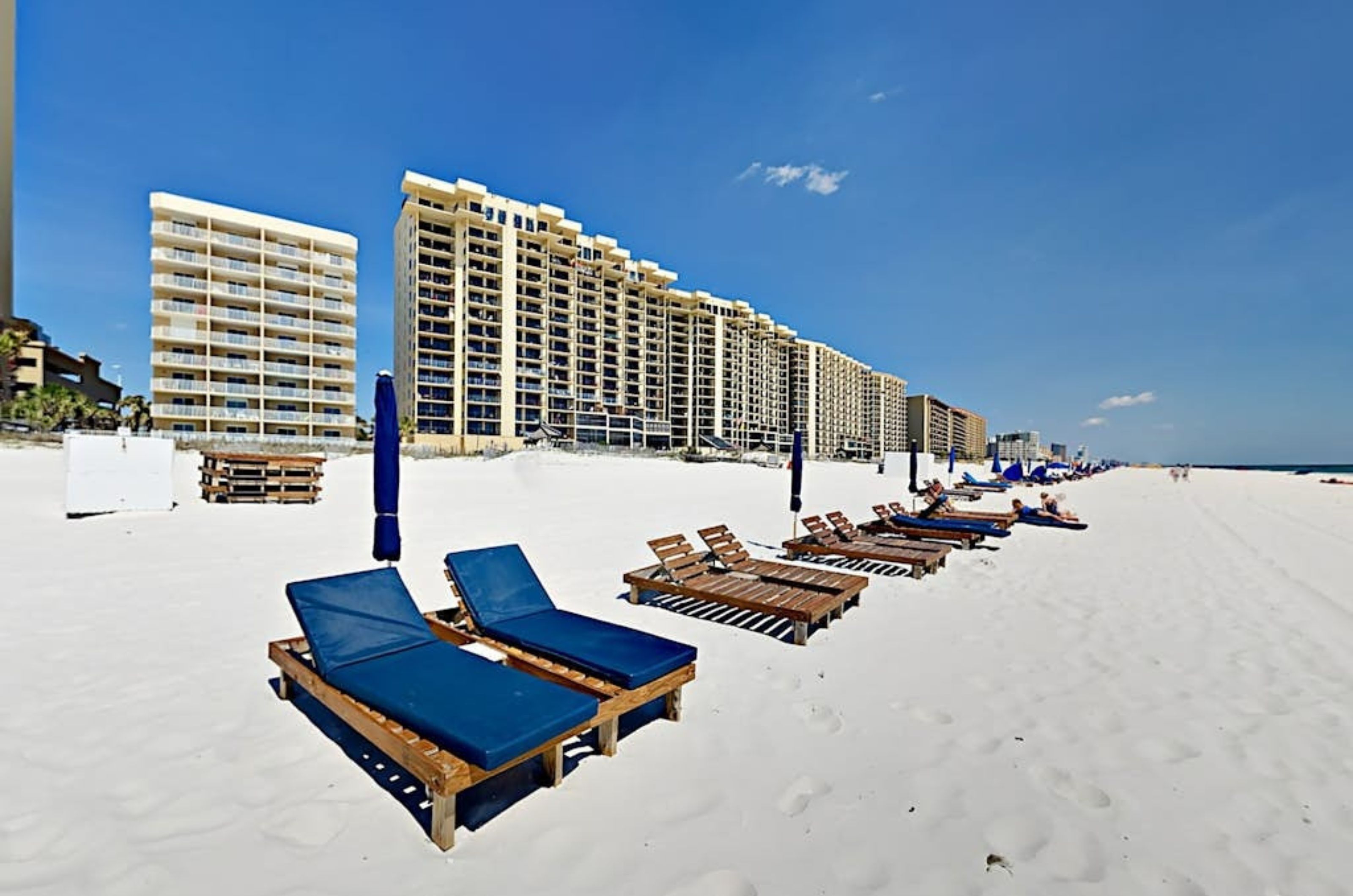 Beach chairs and umbrellas on the beach in front of Four Winds in Orange Beach Alabama 