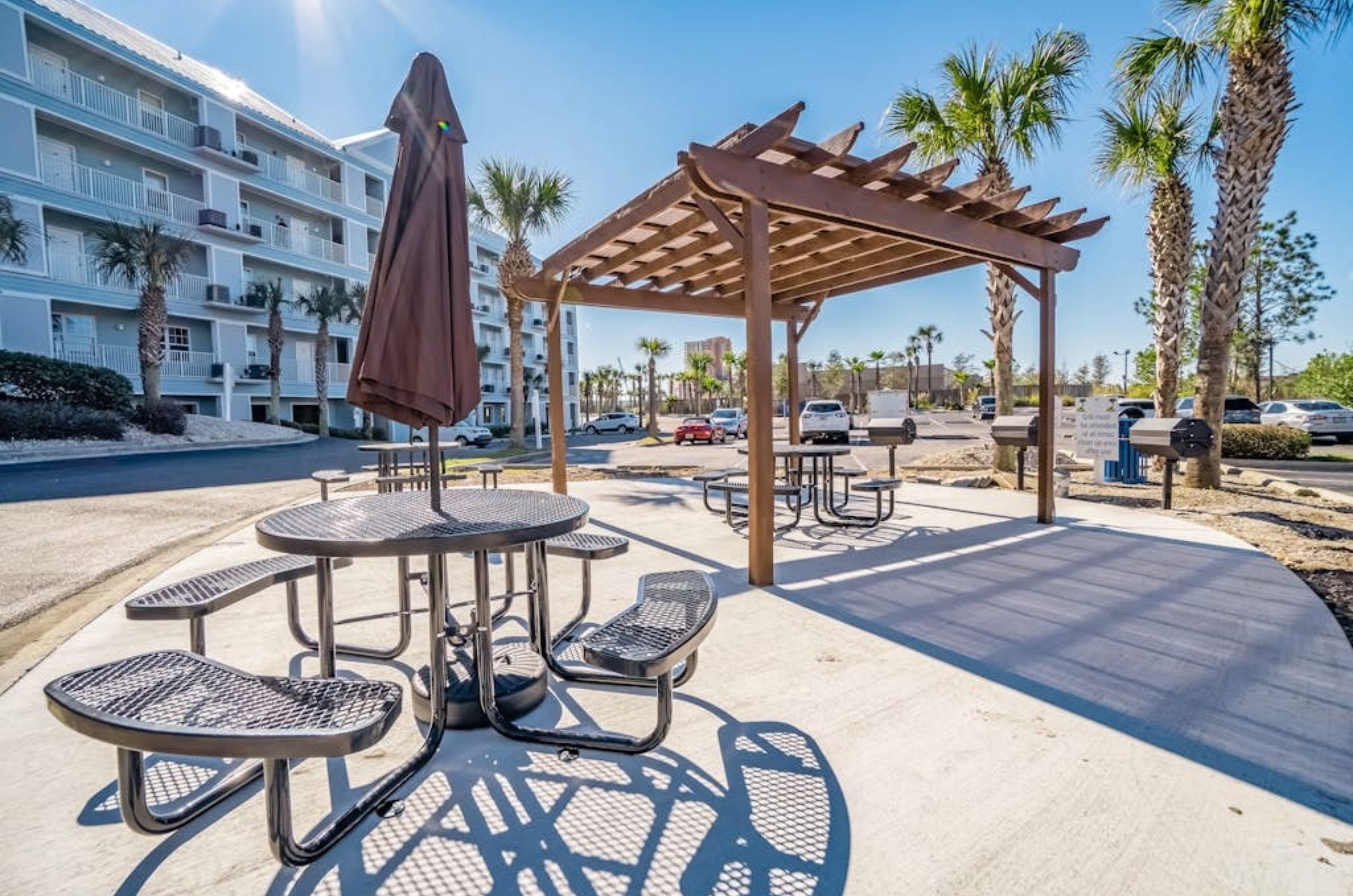 The outdoor patio and gazebo with picnic tables and barbecue grills 