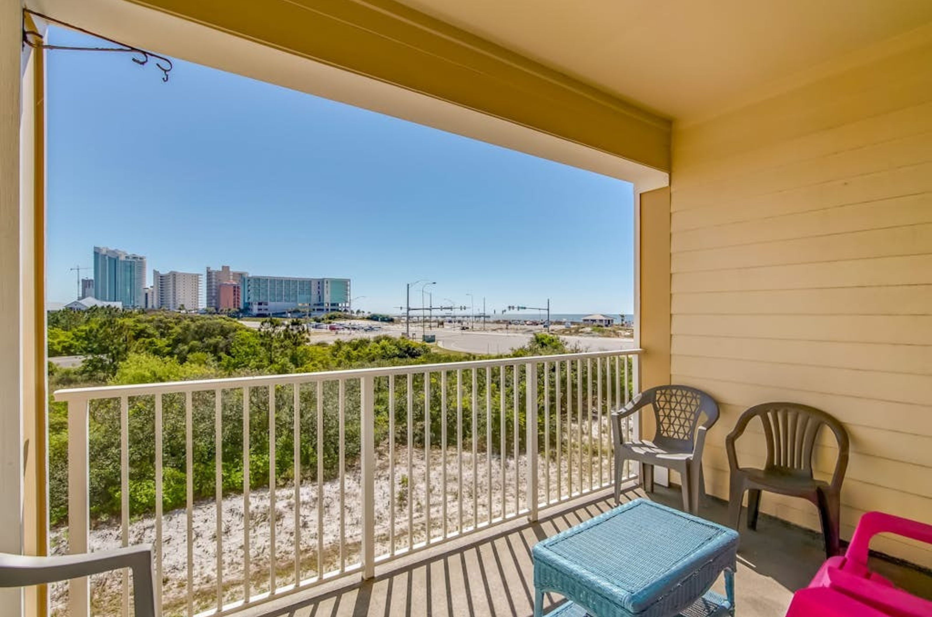 A private balcony with chairs and tables at Grand Caribbean in Orange Beach Alabama 