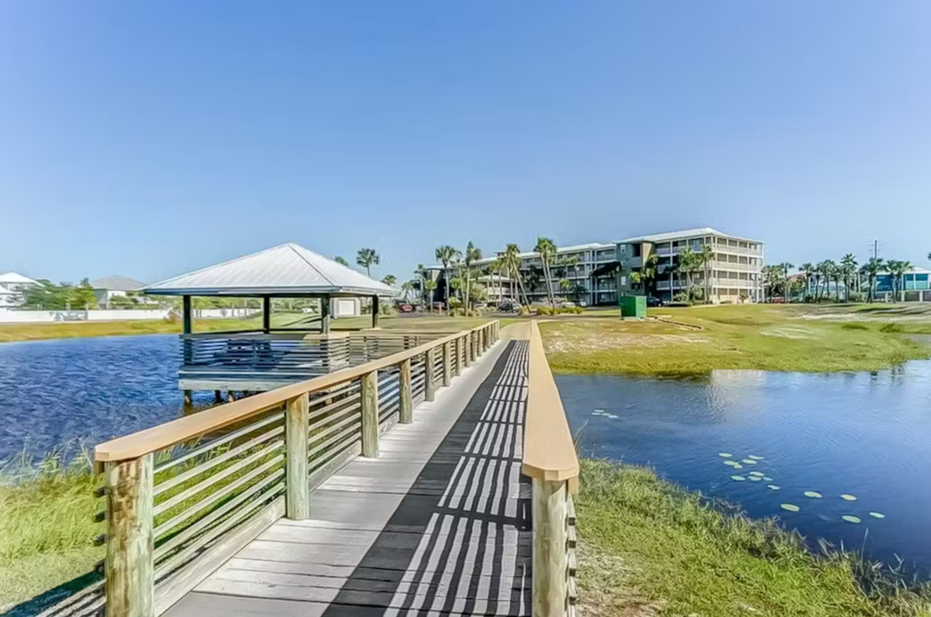 A gazebo and wooden pier next to a freshwater lake