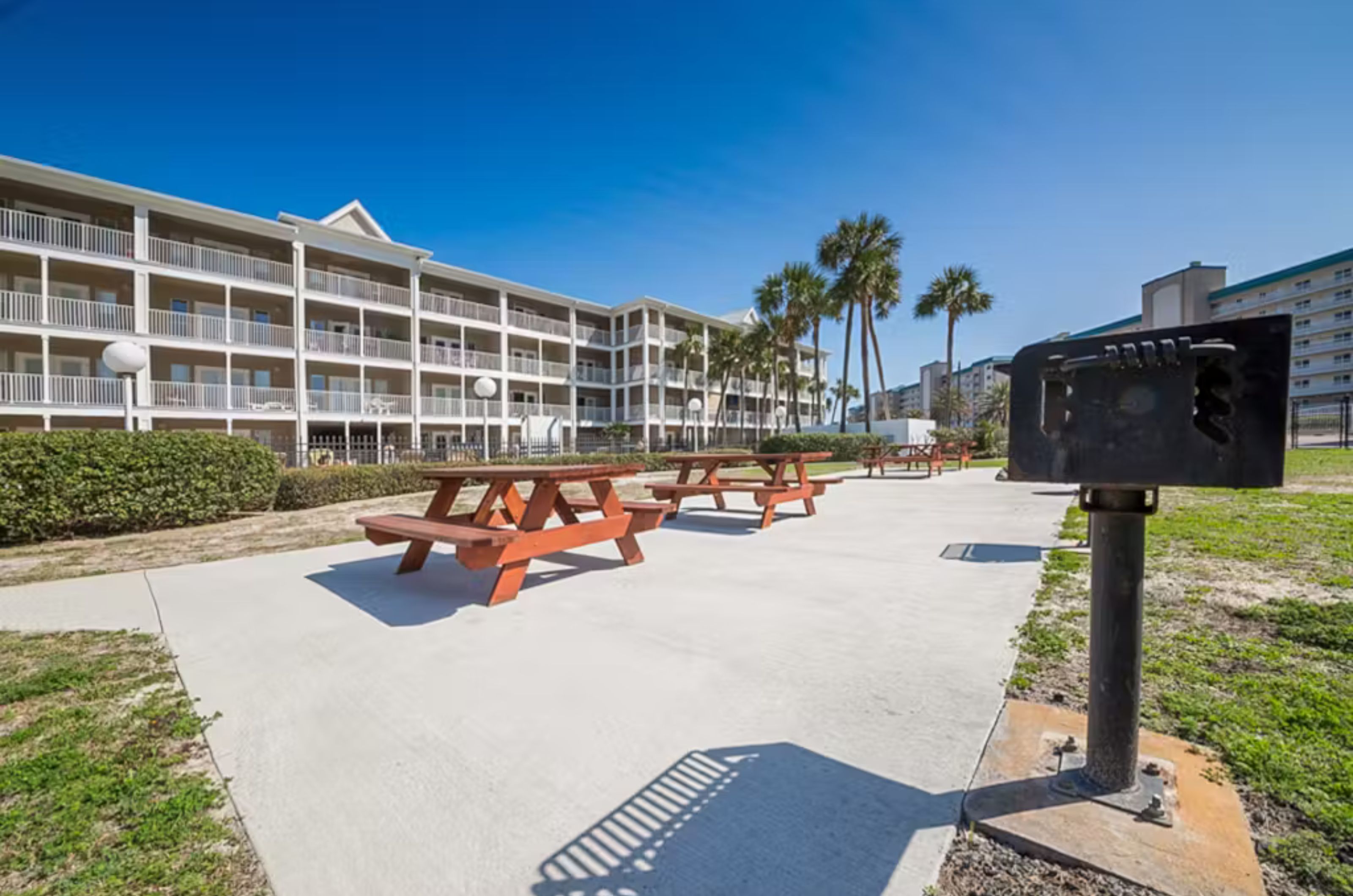 Outdoor patio with picnic tables and barbecue grills 