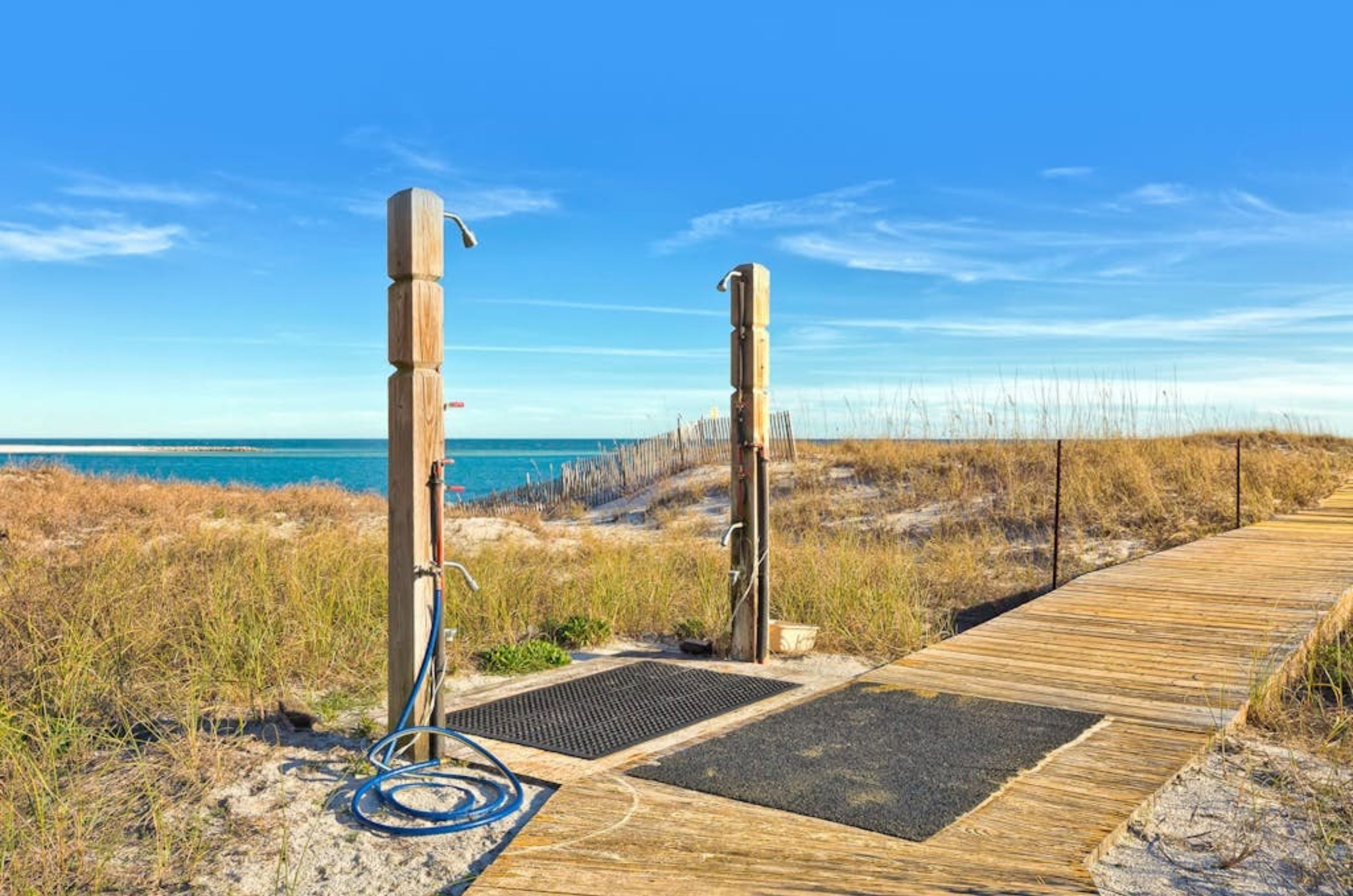 The outdoor showers at the end of a wooden pathway to the beach at Grand Pointe