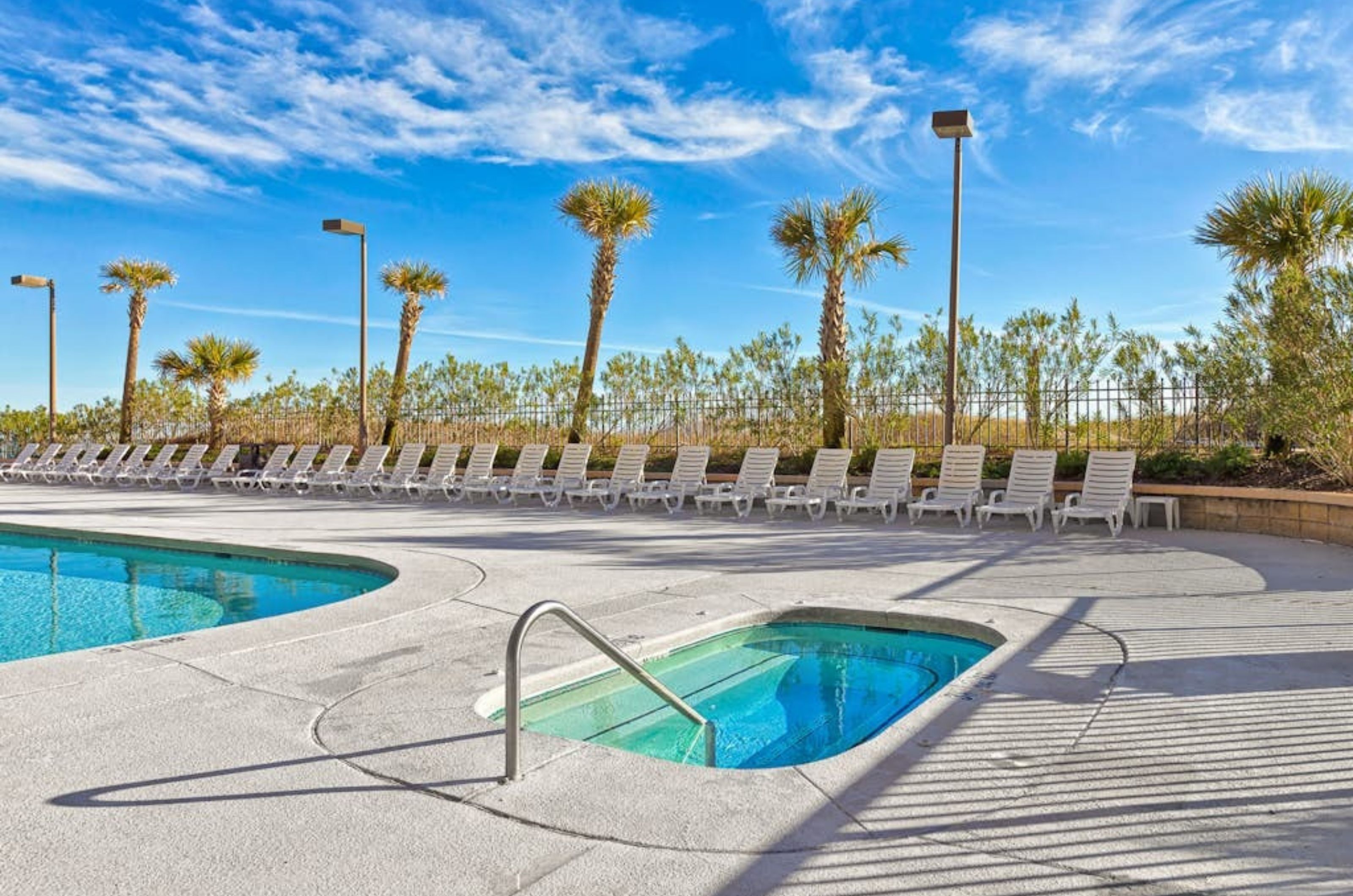 The outdoor hot tub next to the outdoor swimming pool at Grand Pointe 