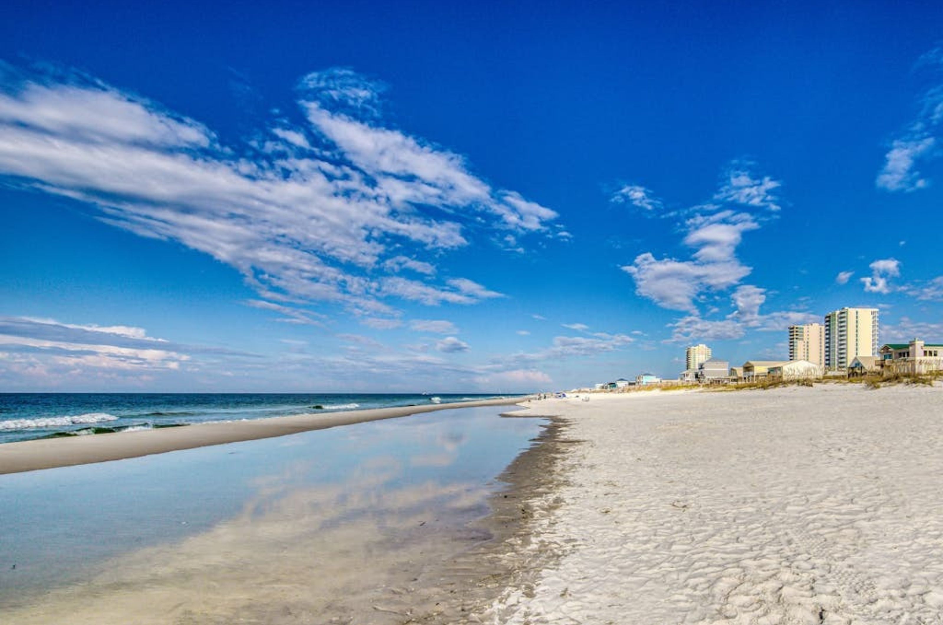 View looking down the coast with pristine white beaches and the Gulf