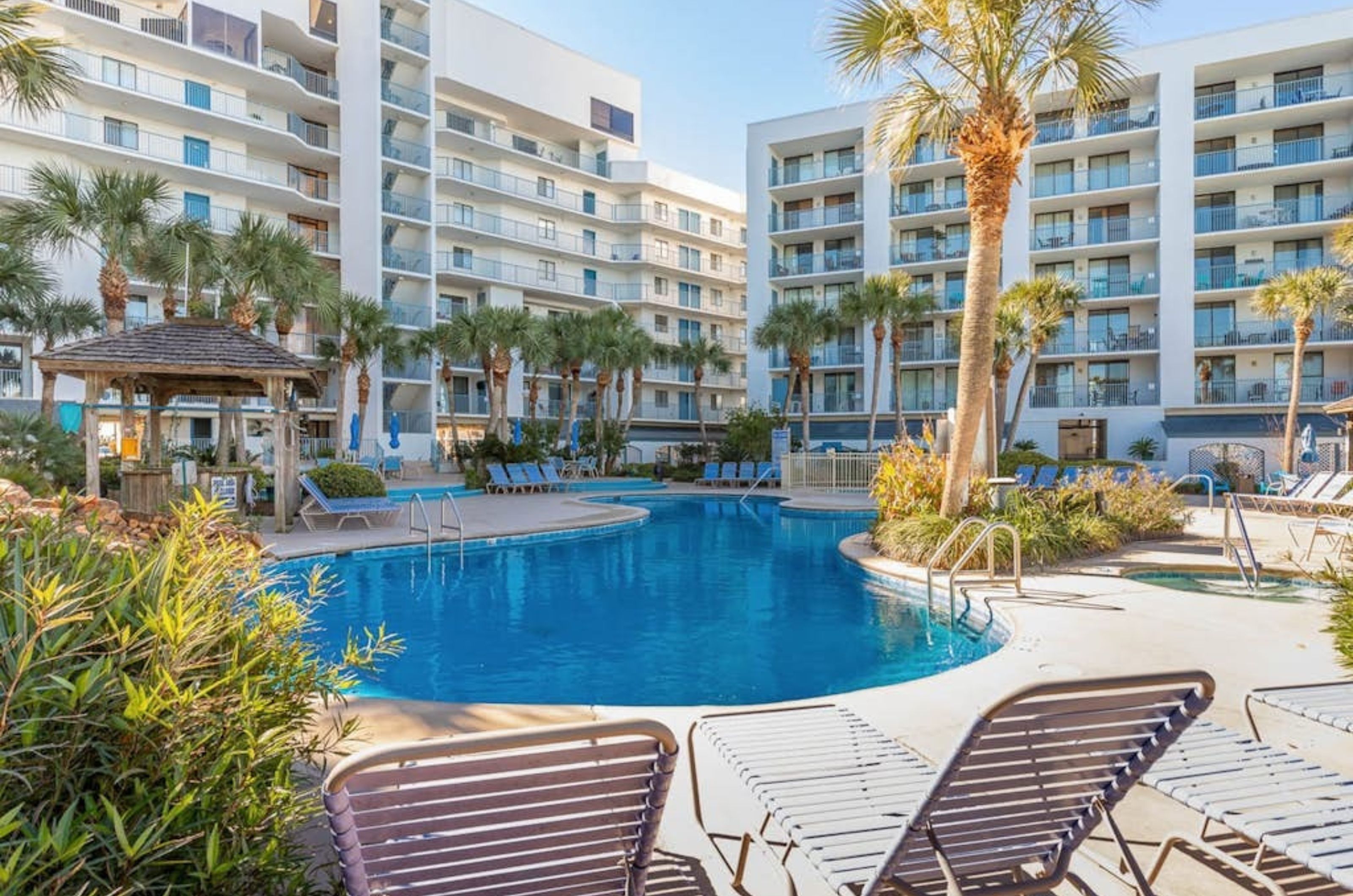 Lounge chairs by the clover-shaped swimming pool at Gulf Shores Surf and Racquet Club in Gulf Shores Alabama 