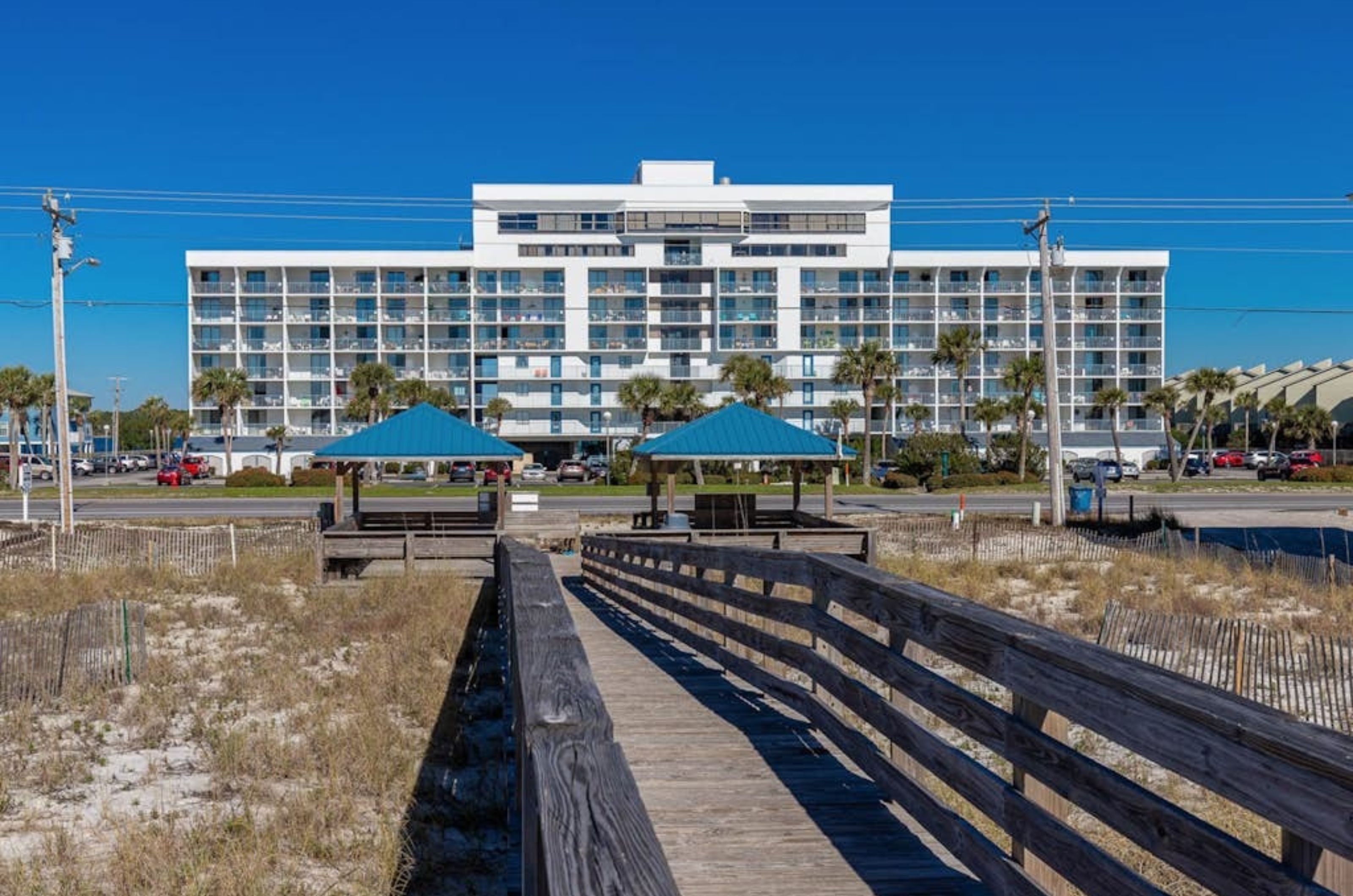 A wooden boardwalk spanning in front of Gulf Shores Surf and Racquet Club in Gulf Shores Alabama 