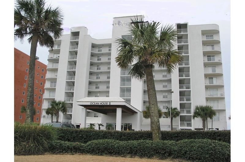 Palm-shaded exterior view from the street at Ocean House Gulf Shores