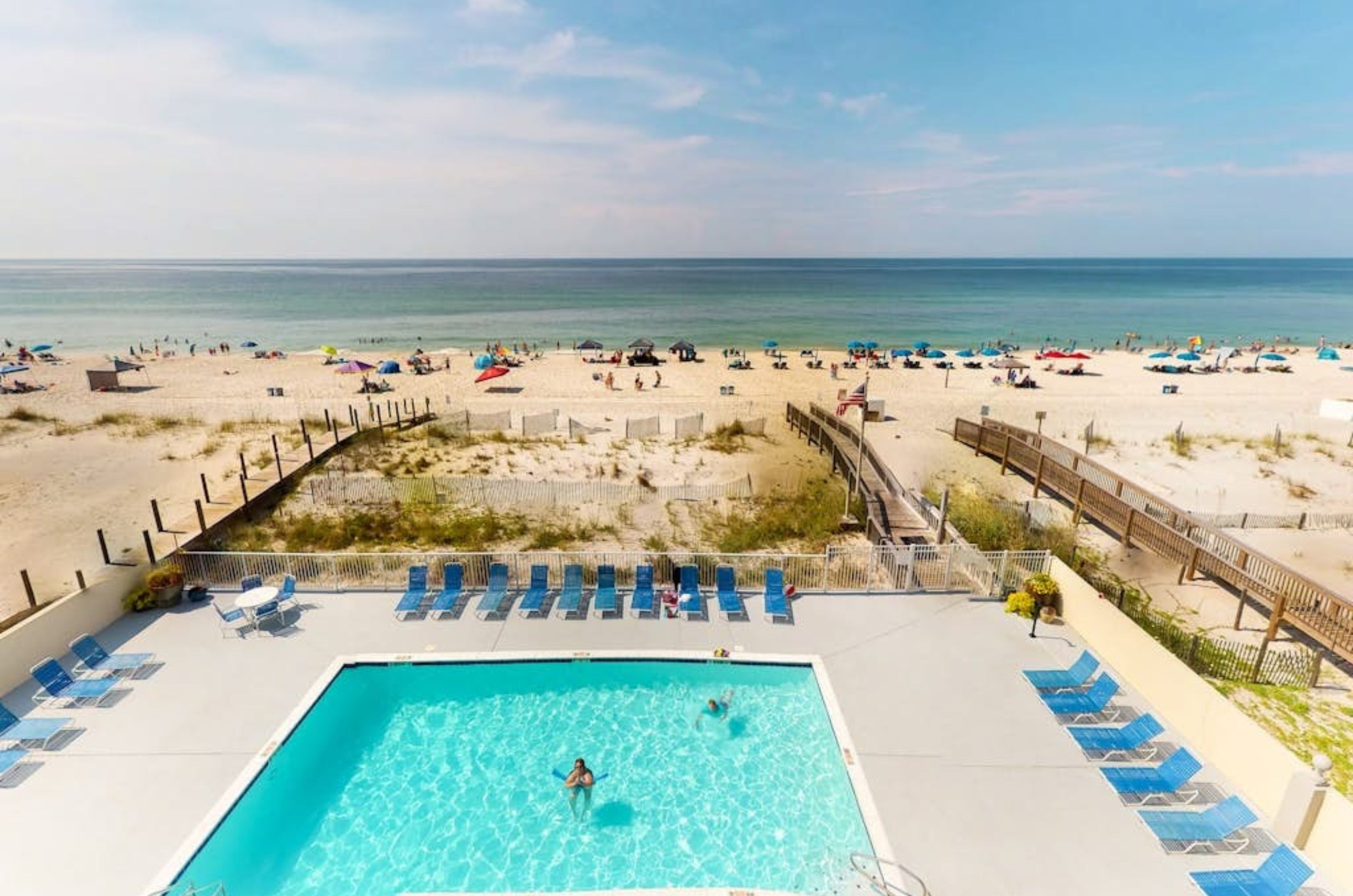 View from a private balcony of the outdoor pool and pool deck next to the beach at Gulf Tower