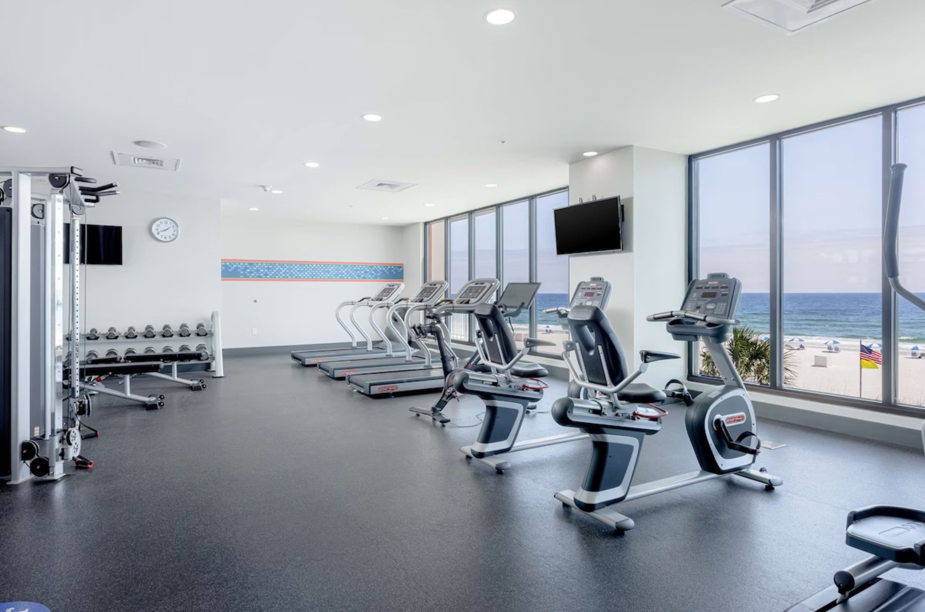 Cardio and strength equipment in the Gulf-facing fitness center	