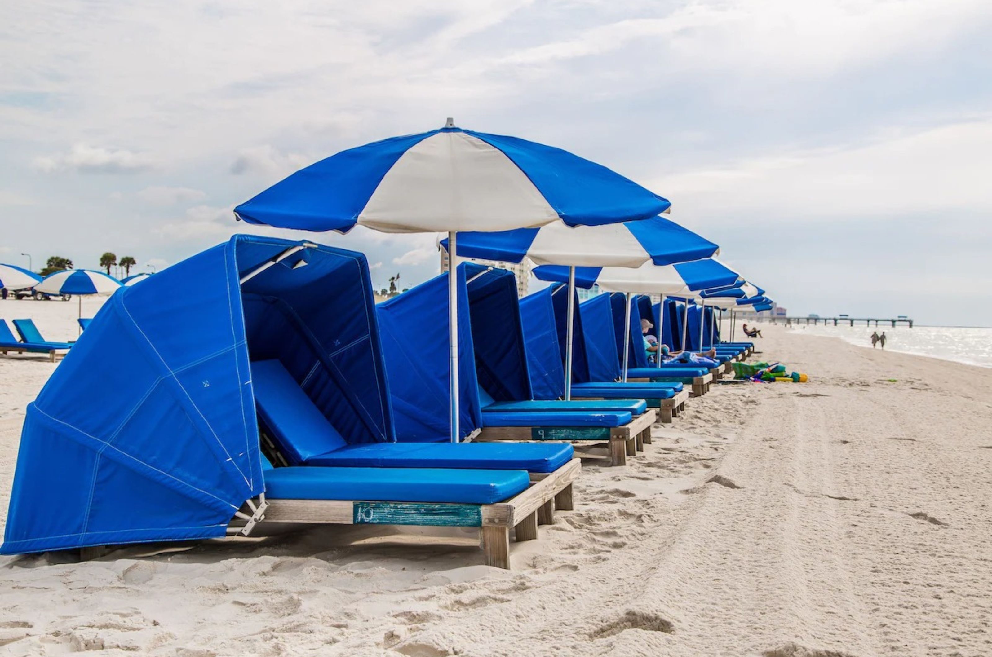 Blue lounge chairs and umbrellas on the beach