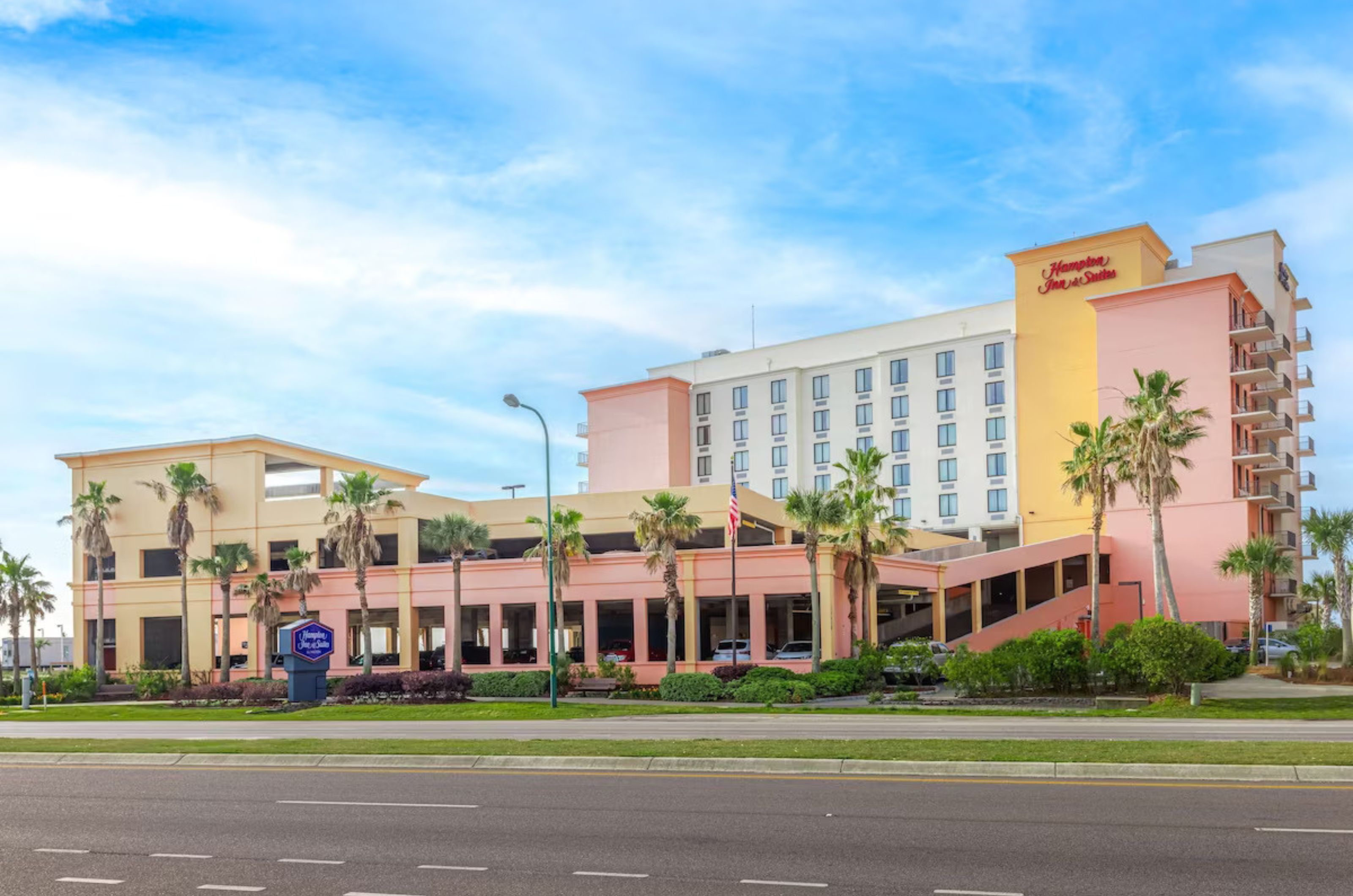 Street view of the exterior of Hampton Inn & Suites and free parking garage 