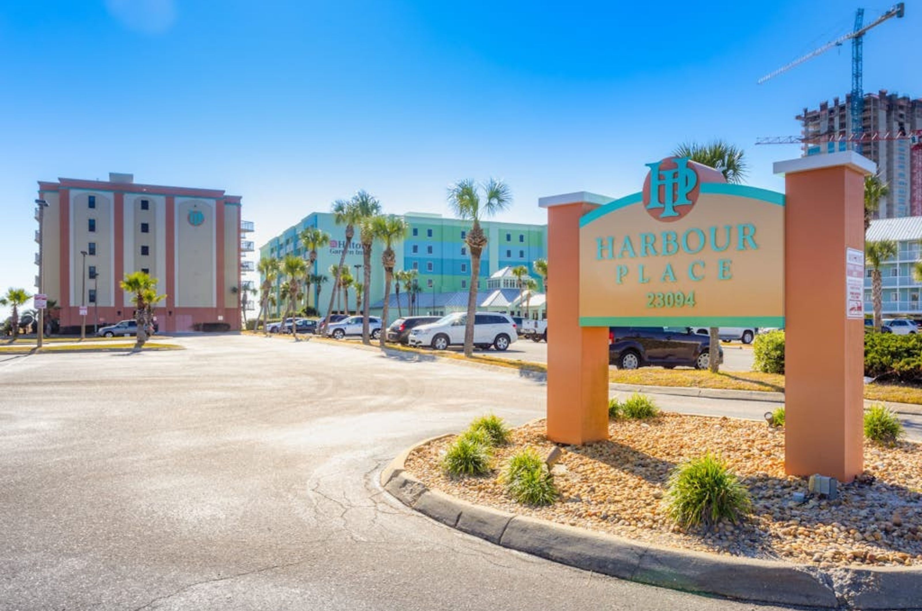 View from the street of Harbour Place and the property's entry sign in Orange Beach Alabama 