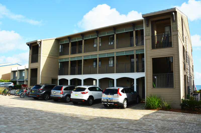 Front side view of Seamist Condominiums in Seacrest Beach FL. Showing a beautiful tan and beige brick parking lot. 30a rentals.