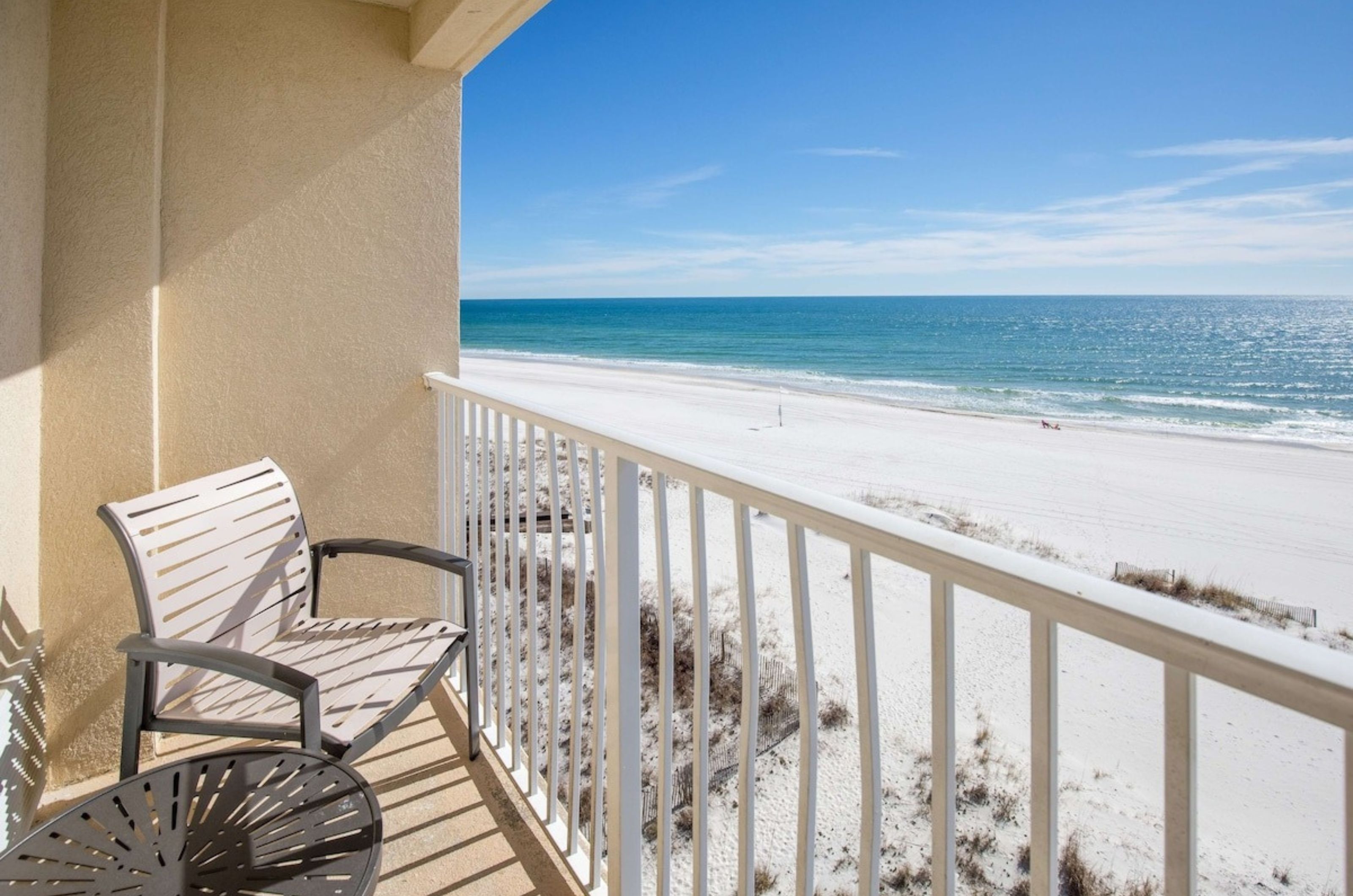 A private balcony with a chair overlooking the Gulf of Mexico at Hilton Garden Inn Orange Beach