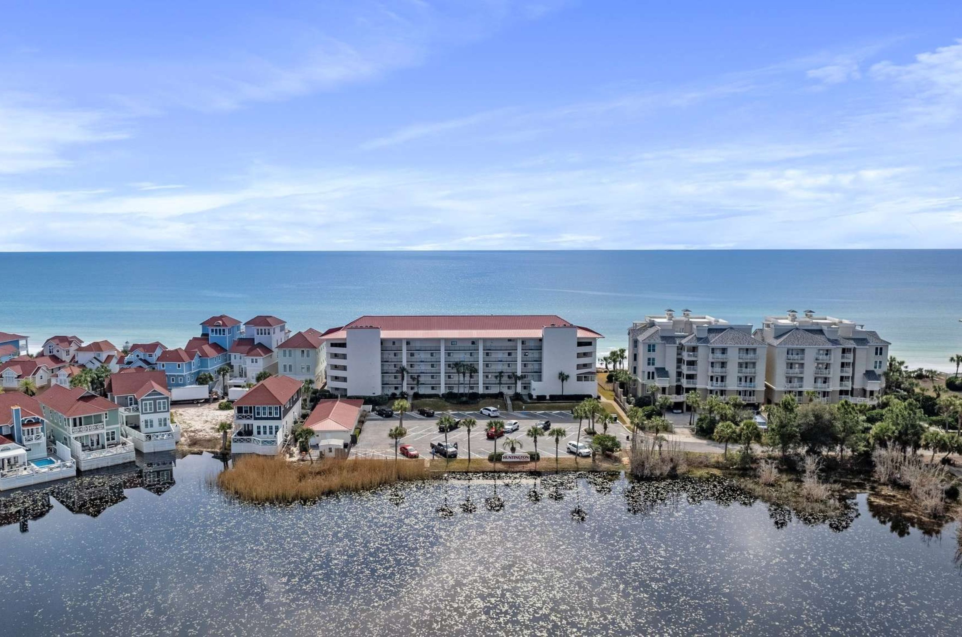 Aerial view of the lowrise condominiums nestled between the Gulf and a small lake