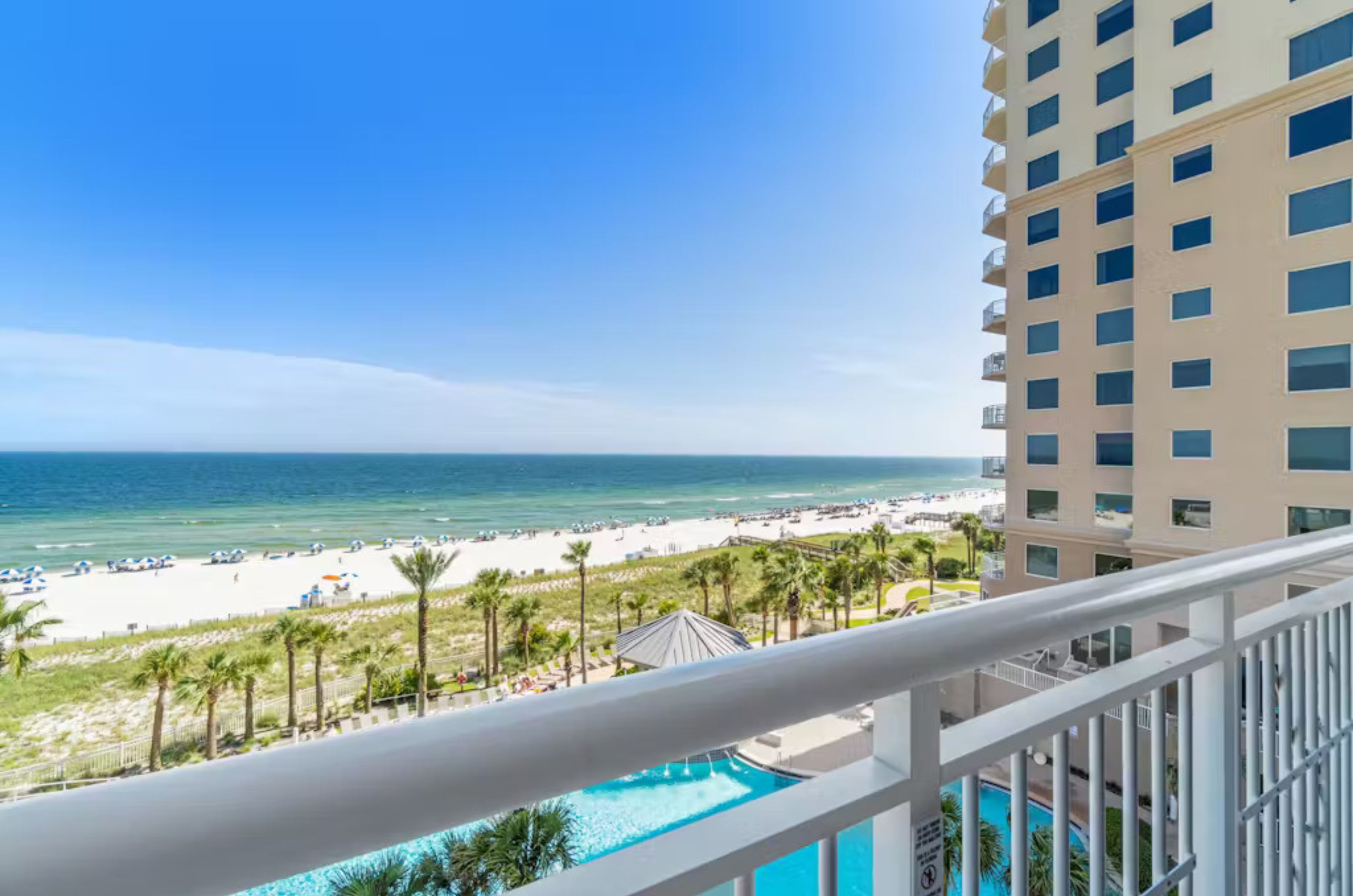 View of the outdoor pool and Gulf of Mexico from a private balcony	