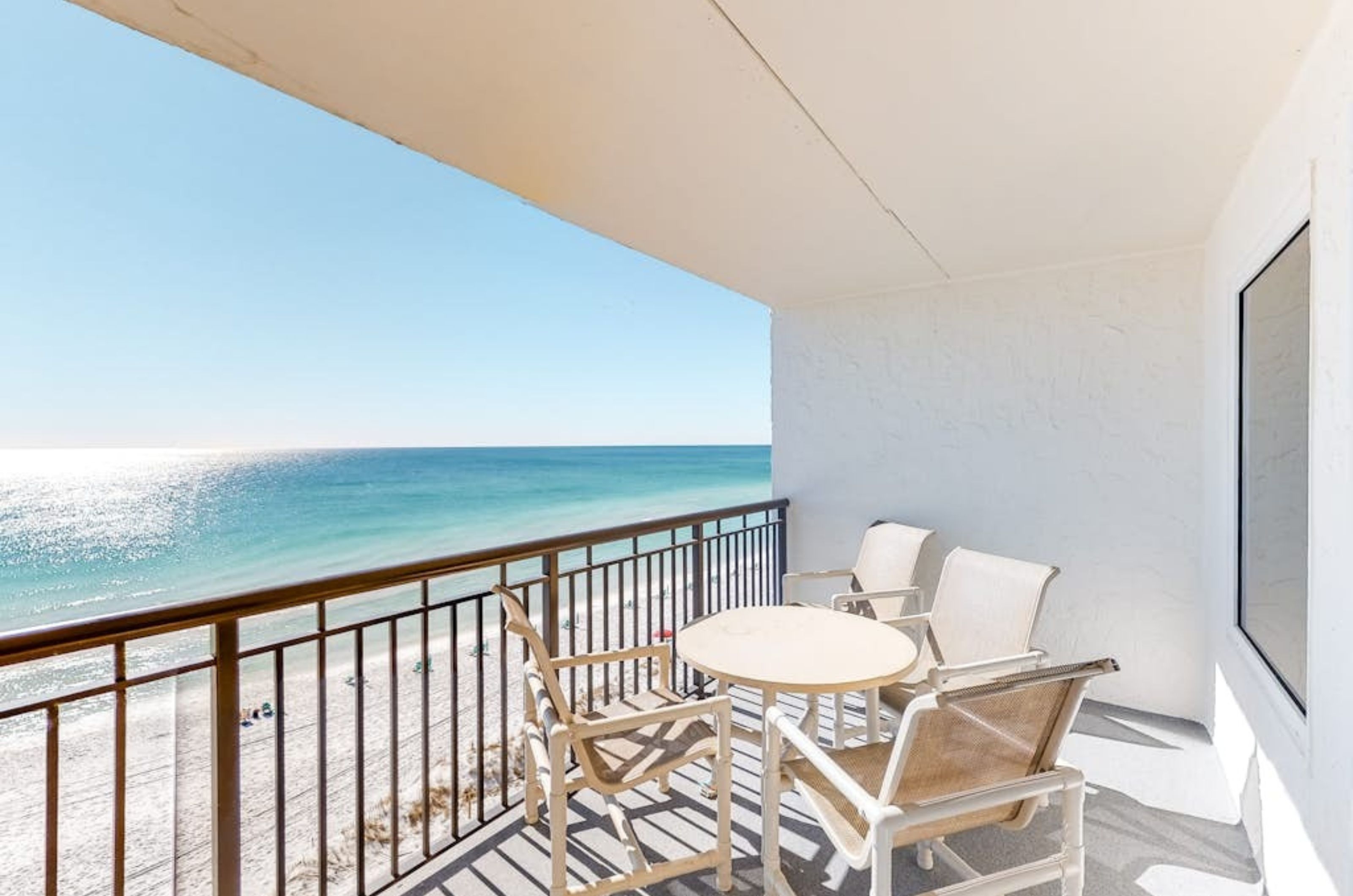 A private balcony with a table and chairs overlooking the Gulf at Island Echos 