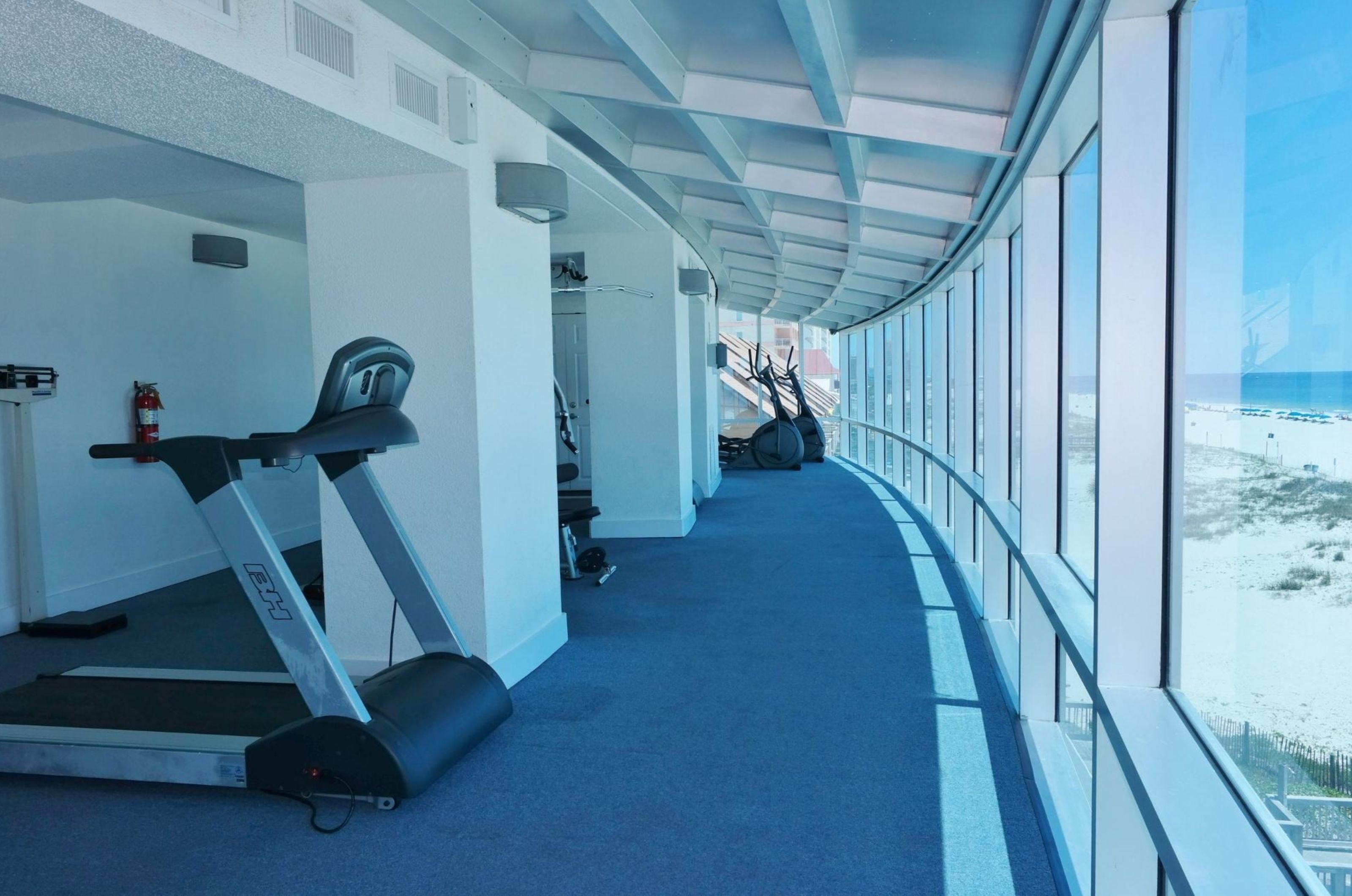 A treadmill facing the windows in the gym at Island Tower in Gulf Shores Alabama 